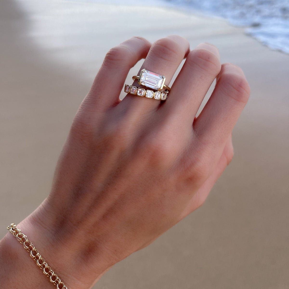 East West Half Bezel Solitaire Engagement Ring With Emerald Cut Diamond - GOODSTONE