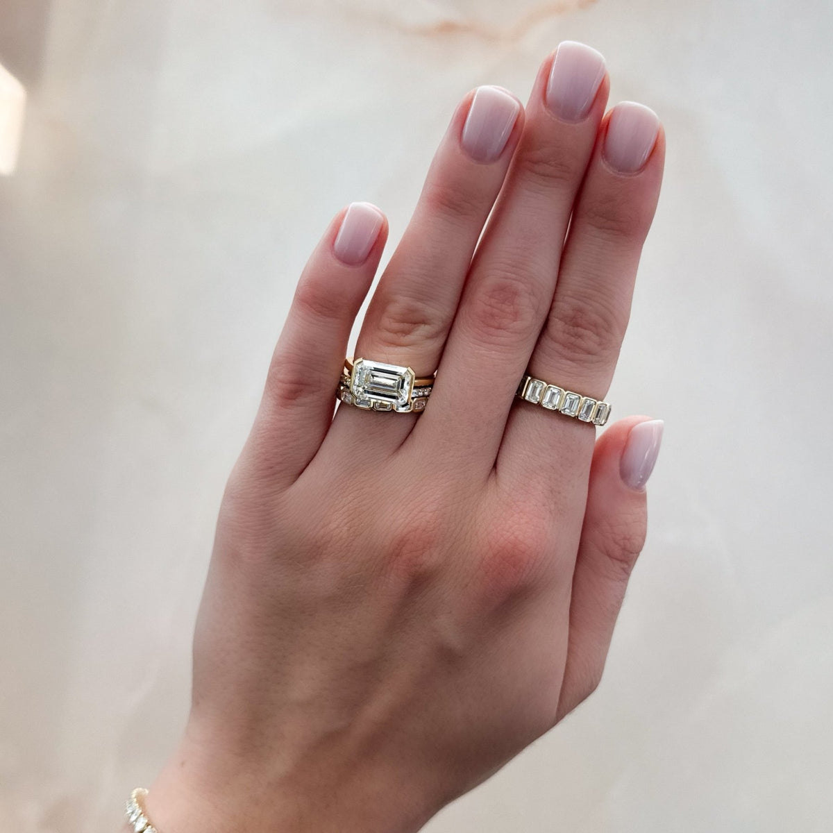 East West Half Bezel Solitaire Engagement Ring With Emerald Cut Diamond - GOODSTONE