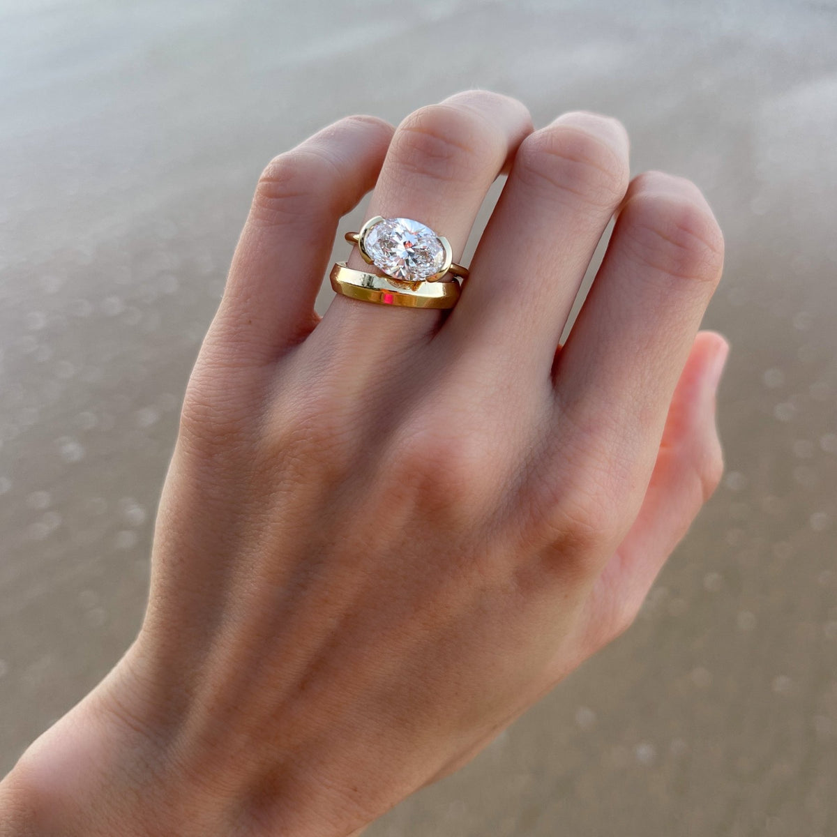 East West Half Bezel Solitaire Engagement Ring With Oval Cut Diamond - GOODSTONE