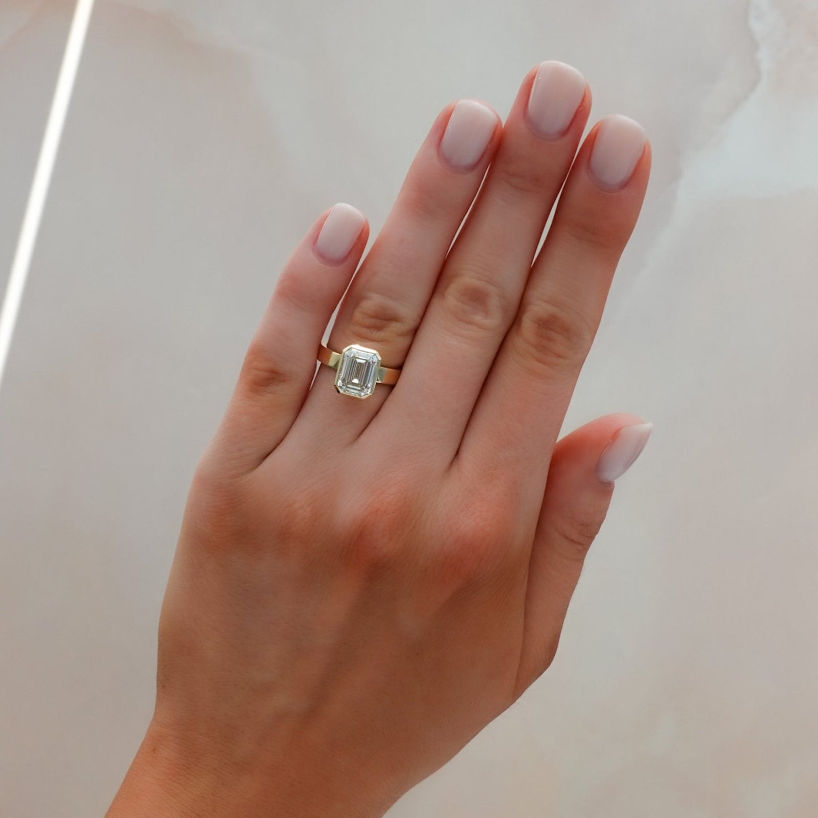 Finest Bezel Set Engagement Ring With 3.05ct Emerald Cut Lab Grown Diamond - GOODSTONE