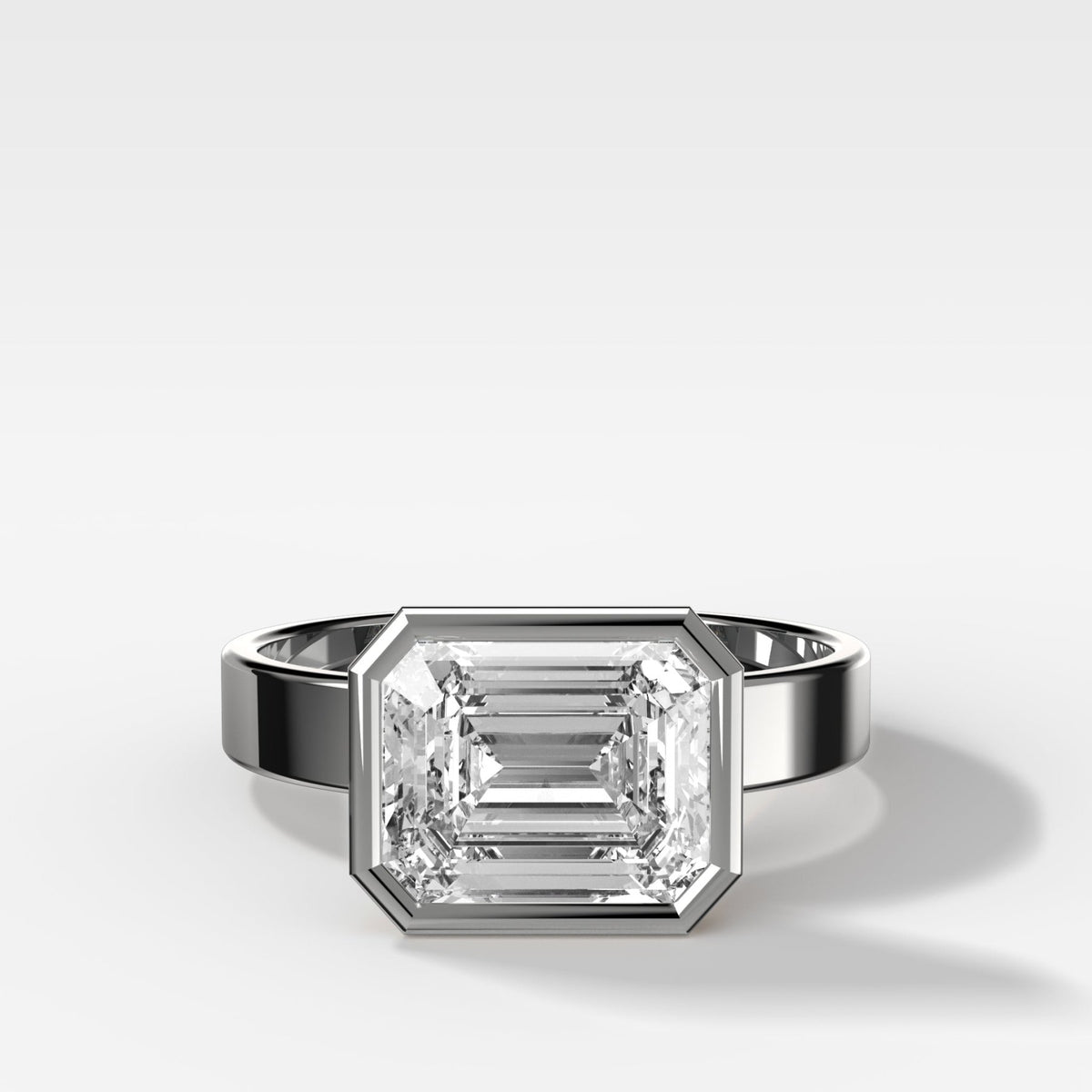 Finest Bezel Set Engagement Ring With East West Emerald Cut Diamond - GOODSTONE