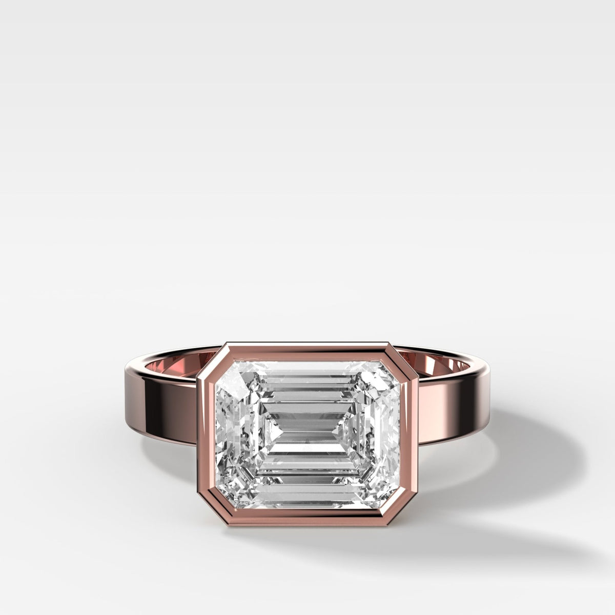 Finest Bezel Set Engagement Ring With East West Emerald Cut Diamond - GOODSTONE
