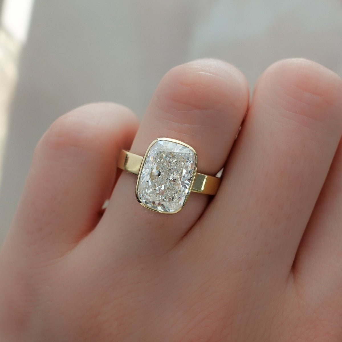 Finest Bezel Set Engagement Ring With Elongated Cushion Cut Diamond - GOODSTONE