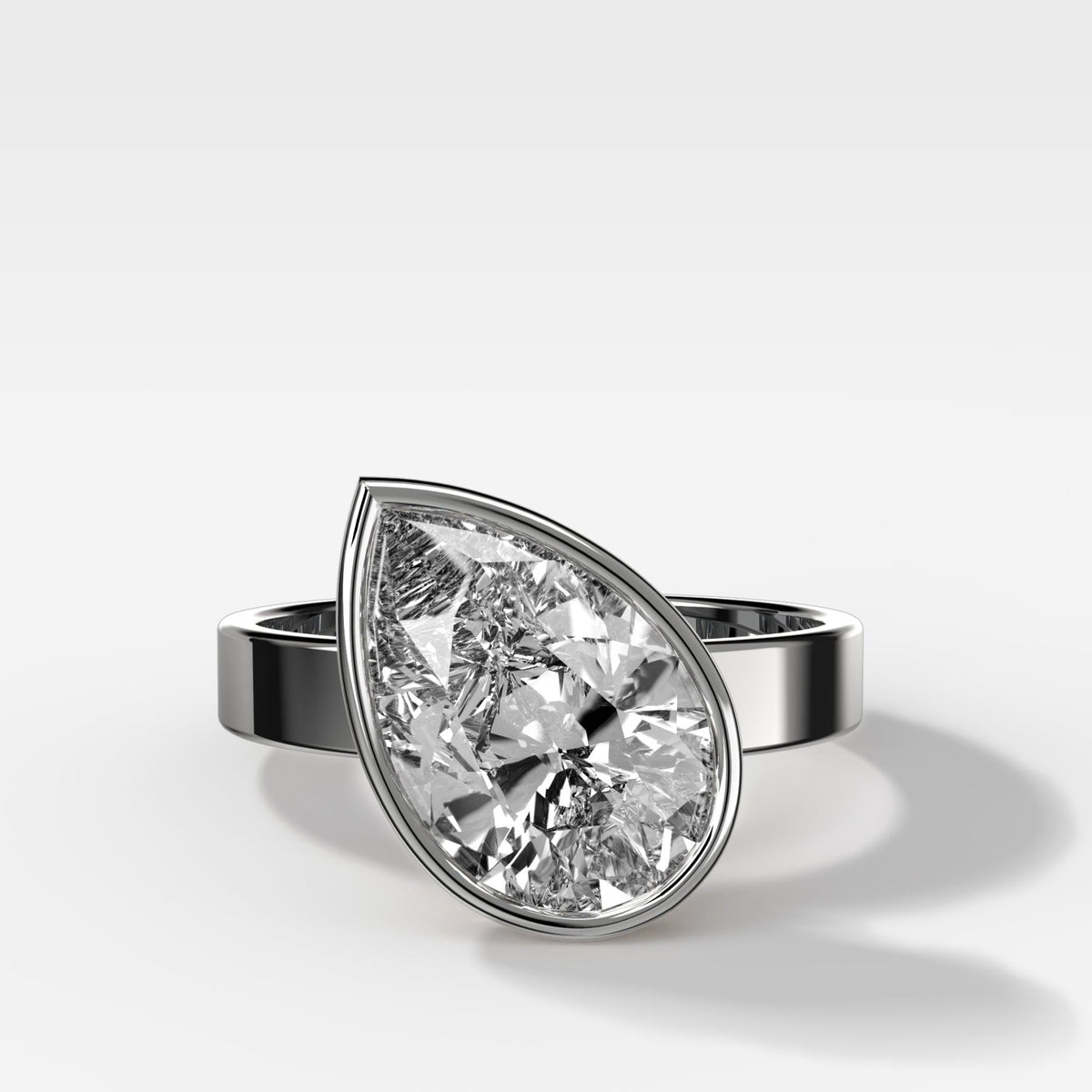 Finest Bezel Set Engagement Ring With Tilted Pear - GOODSTONE
