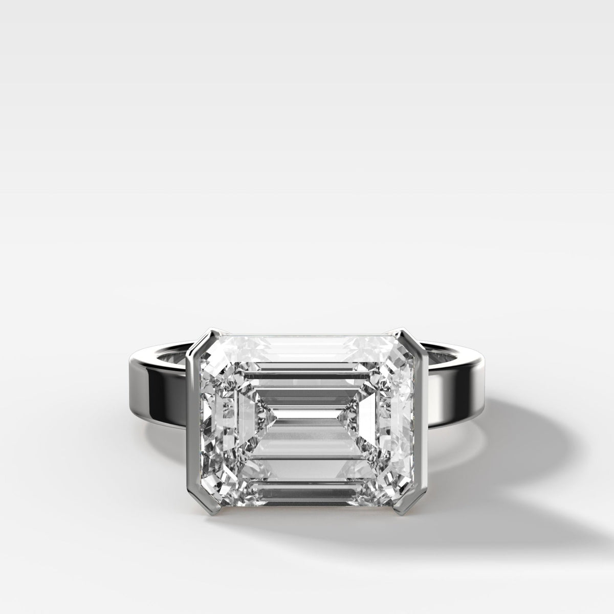 Finest Half Bezel Solitaire Engagement Ring With East West Emerald Cut Diamond - GOODSTONE