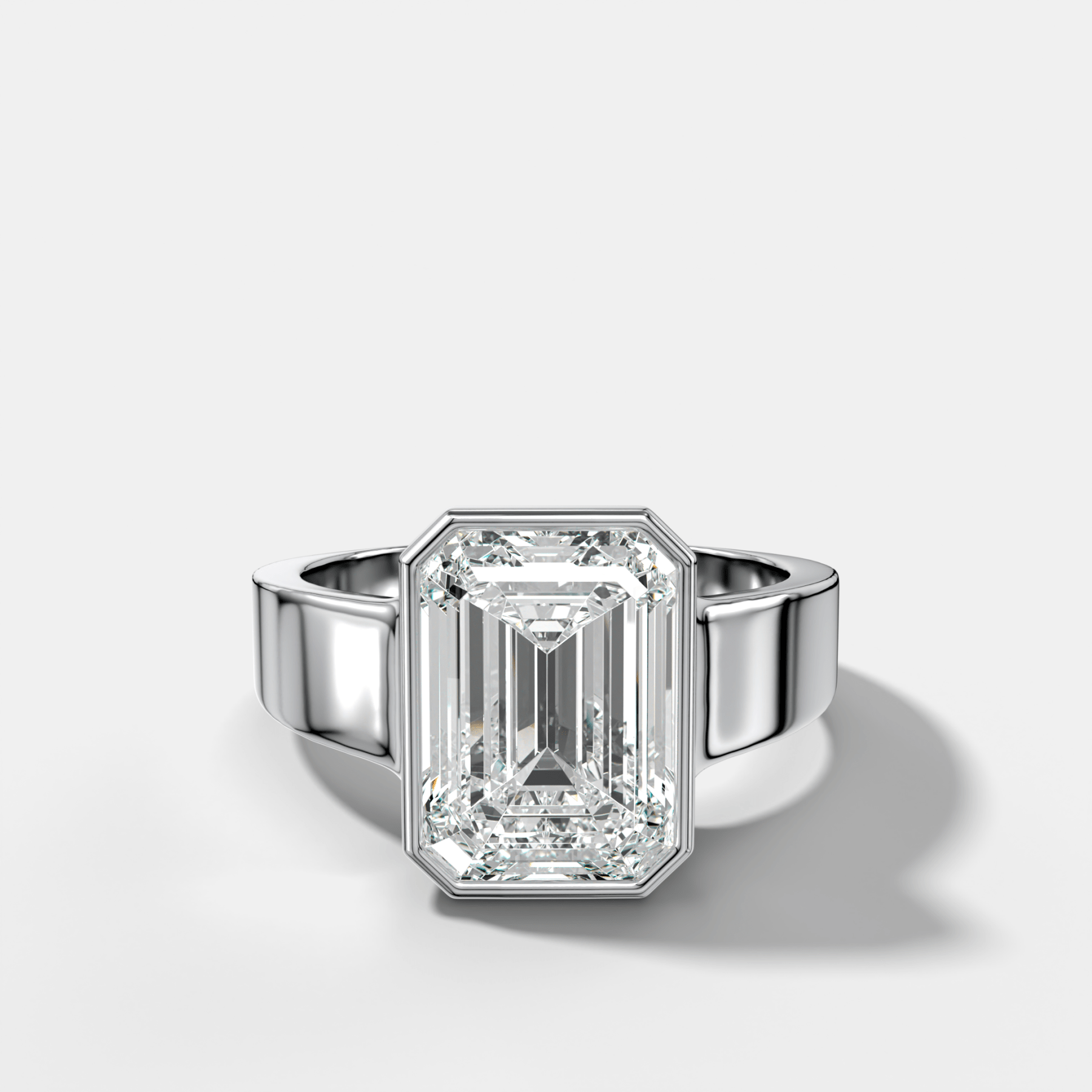 Finest Tapered Bezel Set Engagement Ring With Emerald Cut Diamond - GOODSTONE