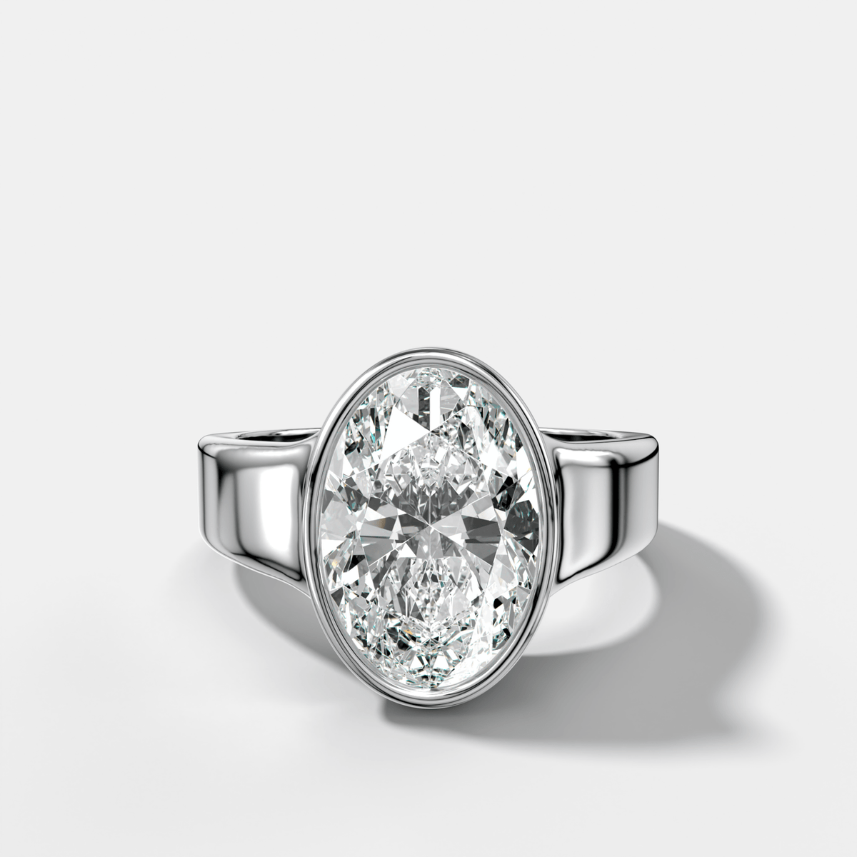 Finest Tapered Bezel Set Engagement Ring With Oval Cut Diamond - GOODSTONE