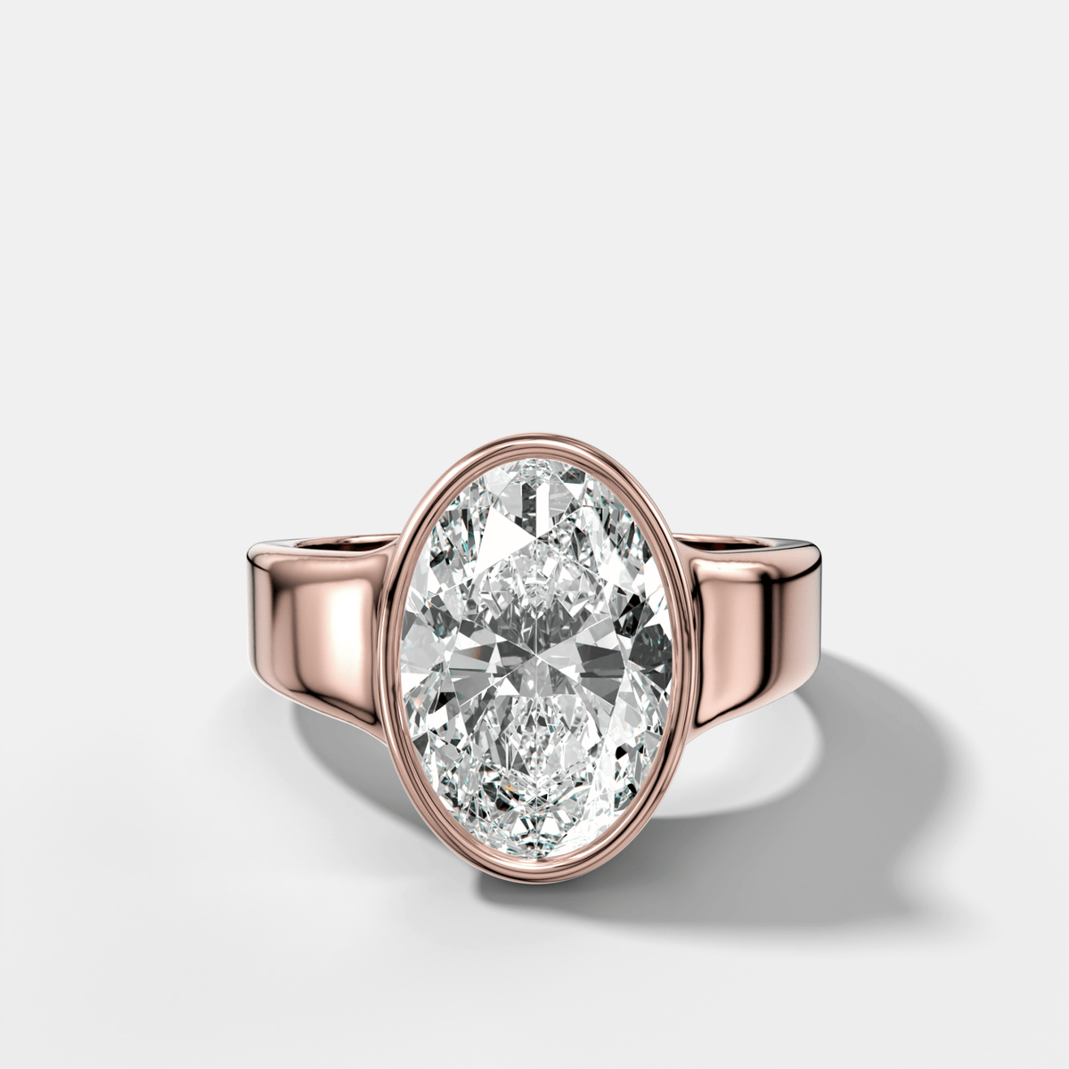 Finest Tapered Bezel Set Engagement Ring With Oval Cut Diamond - GOODSTONE