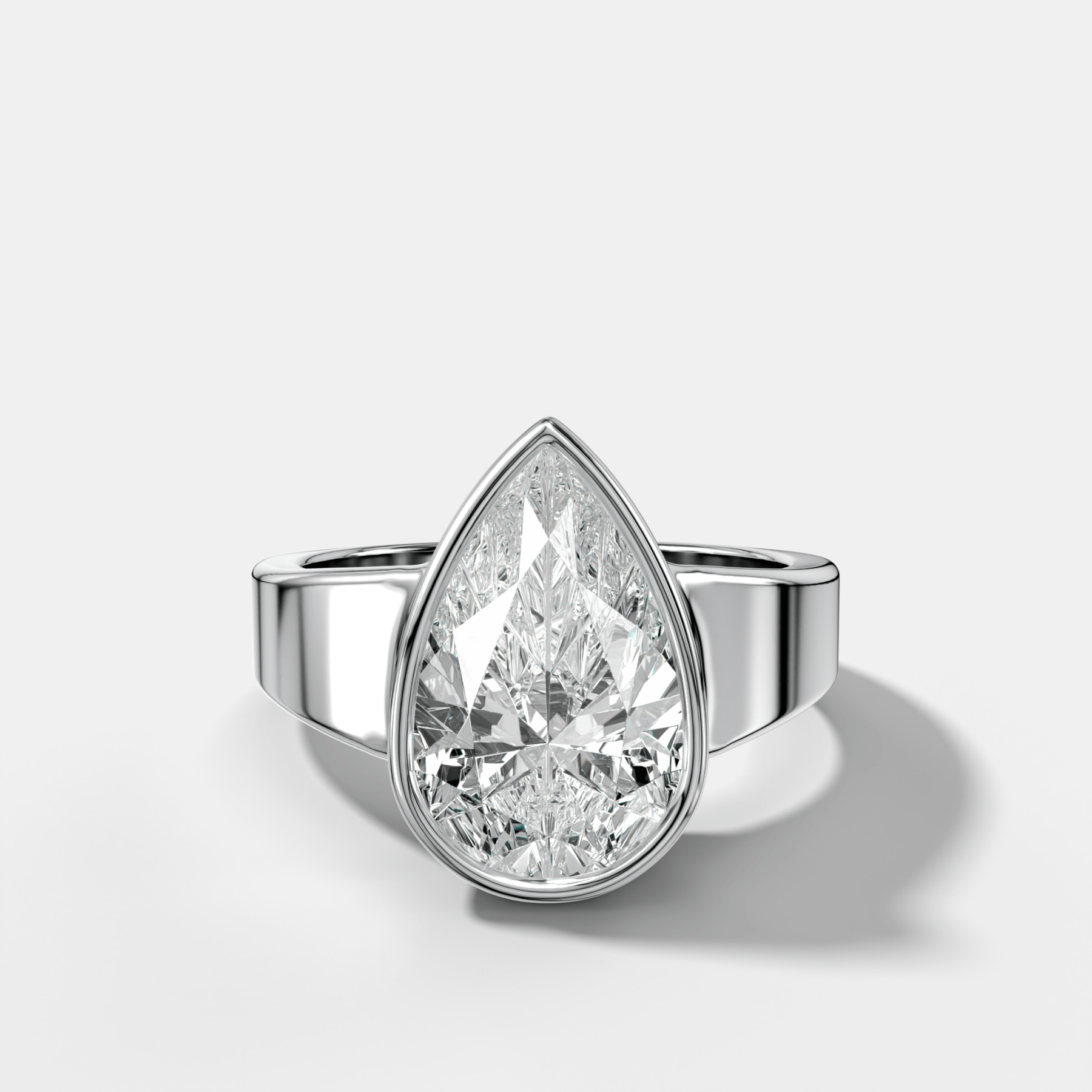 Finest Tapered Bezel Set Engagement Ring With Pear Cut Diamond - GOODSTONE