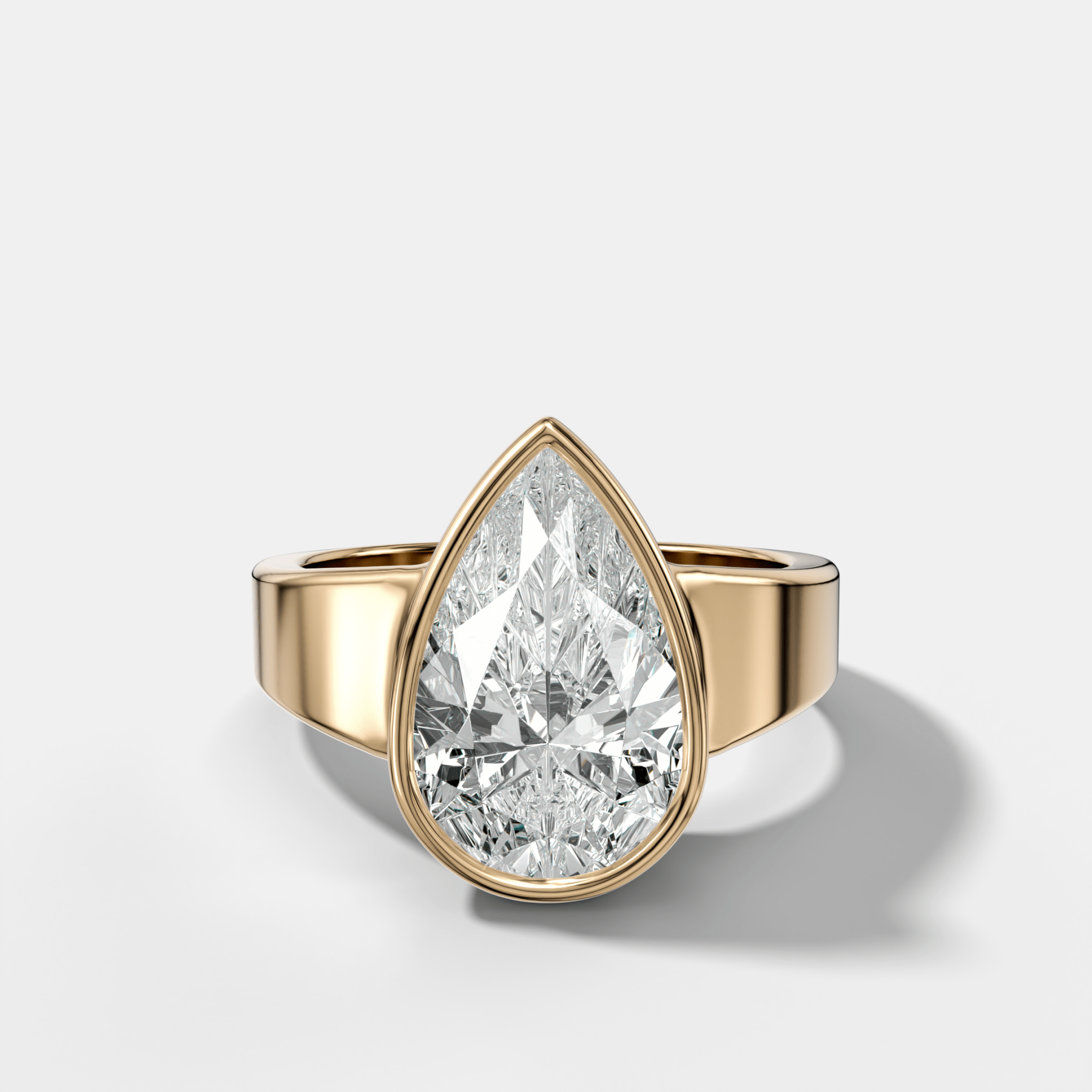 Finest Tapered Bezel Set Engagement Ring With Pear Cut Diamond - GOODSTONE