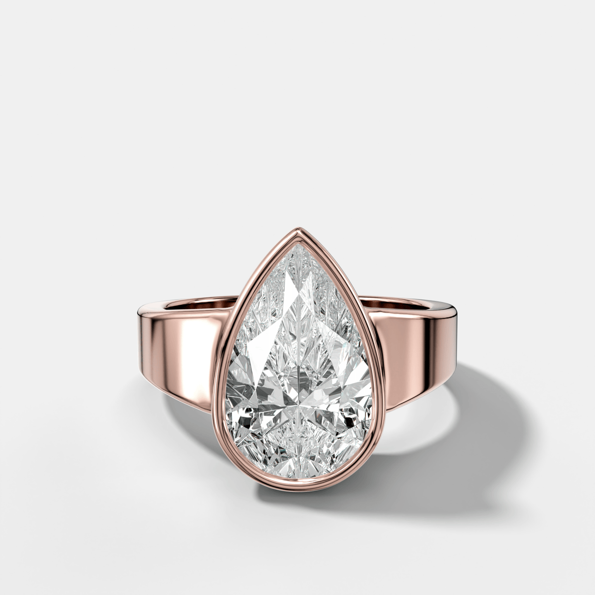 Finest Tapered Bezel Set Engagement Ring With Pear Cut Diamond - GOODSTONE