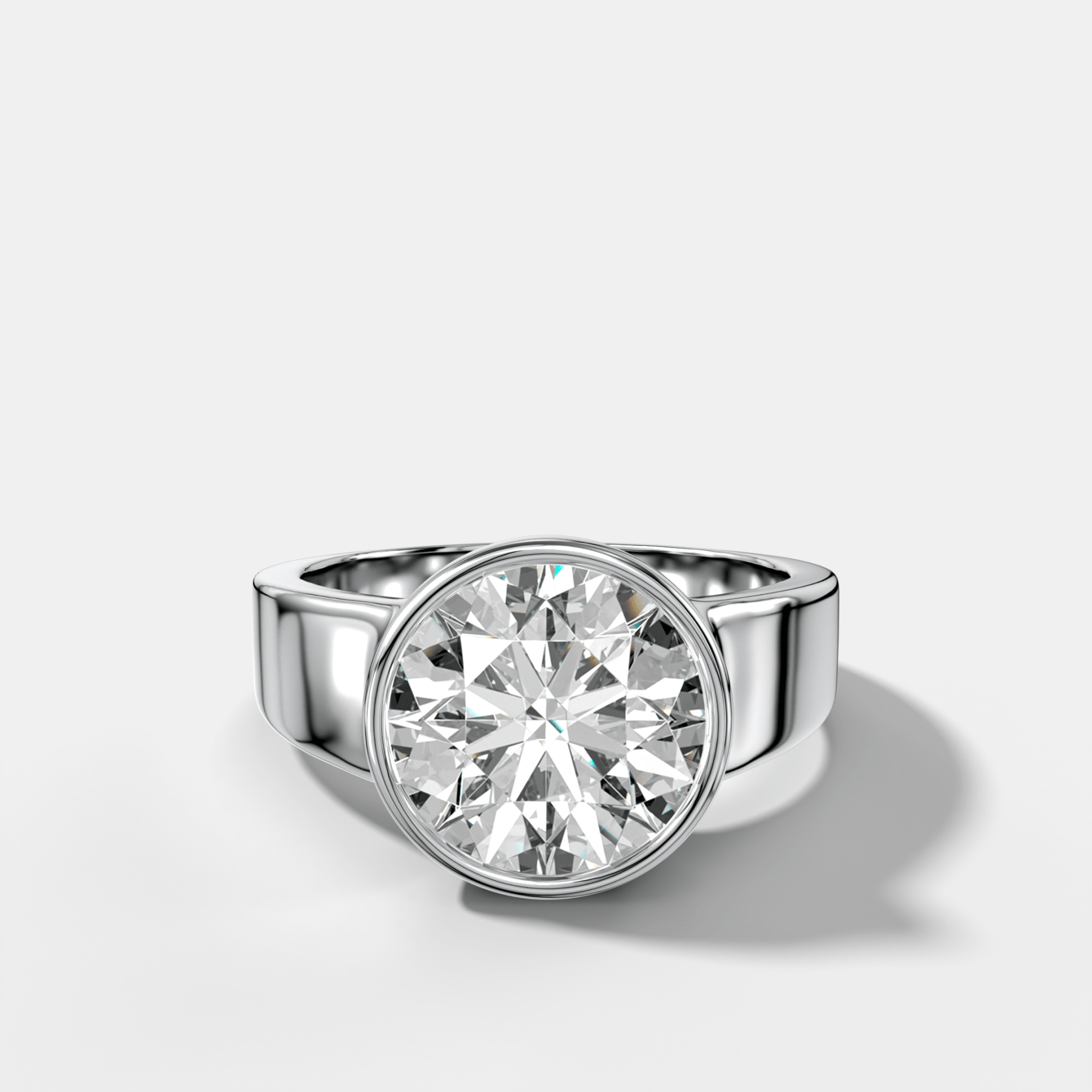Finest Tapered Bezel Set Engagement Ring With Round Cut Diamond - GOODSTONE