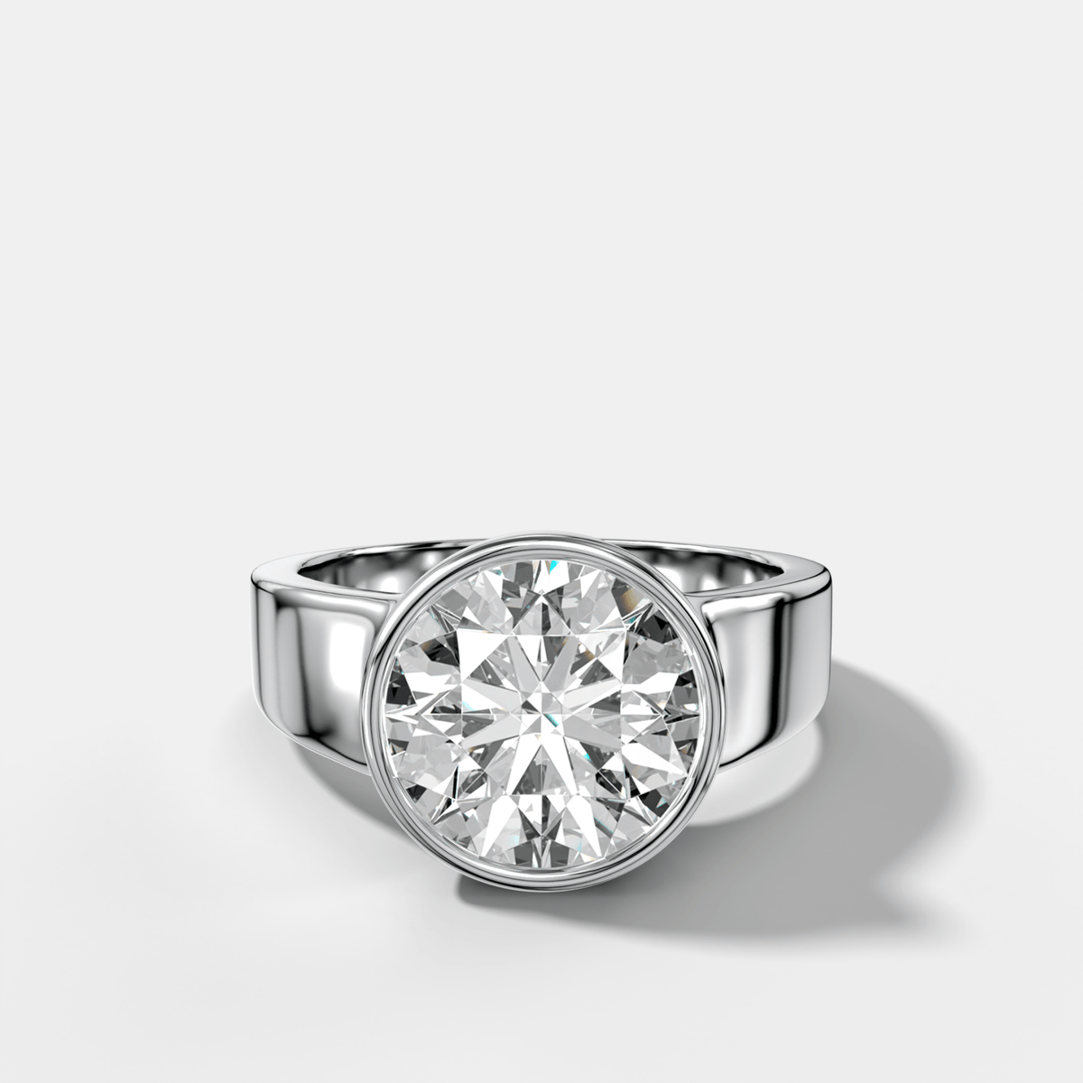 Finest Tapered Bezel Set Engagement Ring With Round Cut Diamond - GOODSTONE