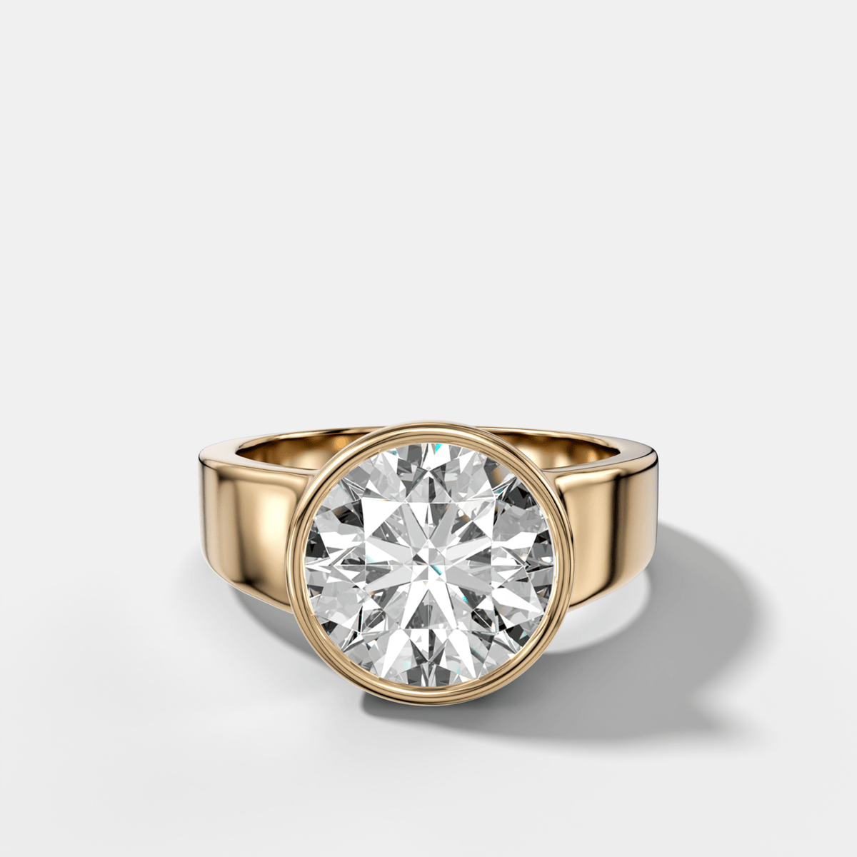 Finest Tapered Bezel Set Engagement Ring With Round Cut Diamond - GOODSTONE