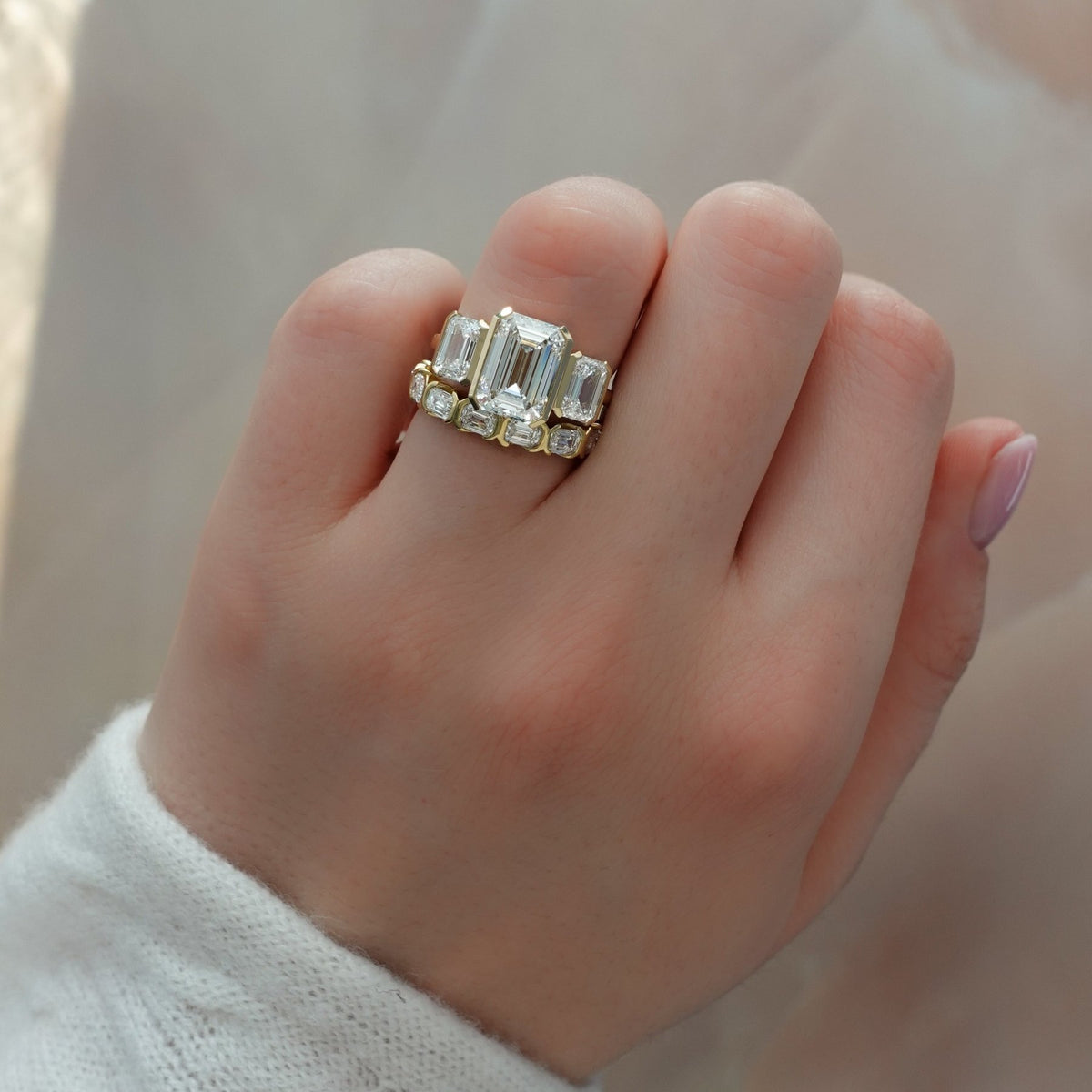 Half Bezel Triad Engagement Ring With Emerald Cut Diamonds - GOODSTONE