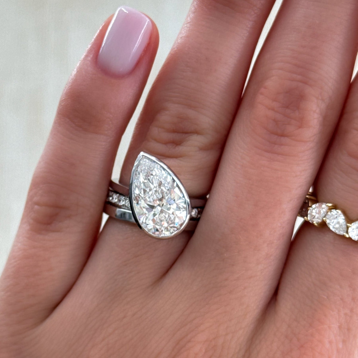 Penumbra Bezel Set Engagement Ring With Tilted Pear Cut - GOODSTONE