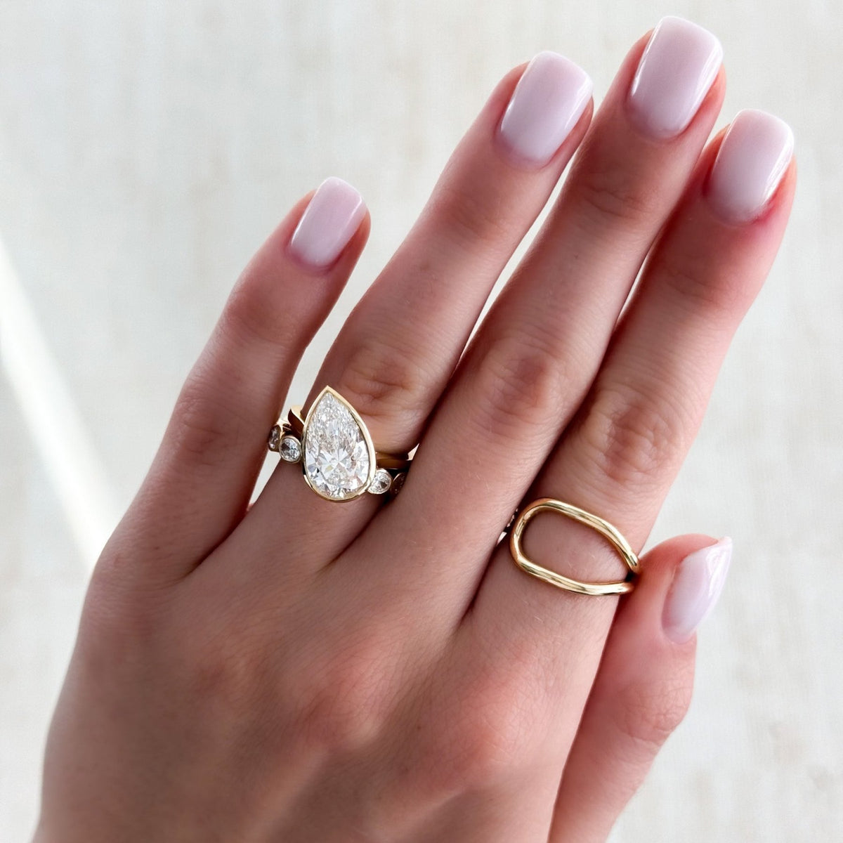 Penumbra Bezel Set Engagement Ring With Tilted Pear Cut - GOODSTONE