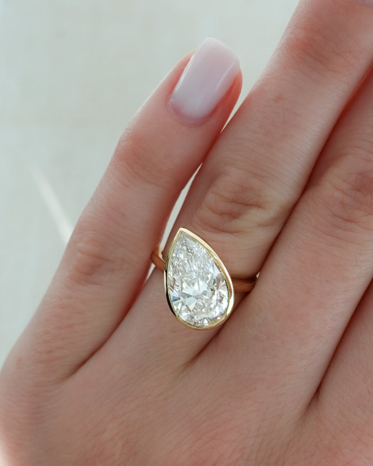 Penumbra Bezel Set Engagement Ring With Tilted Pear Cut - GOODSTONE