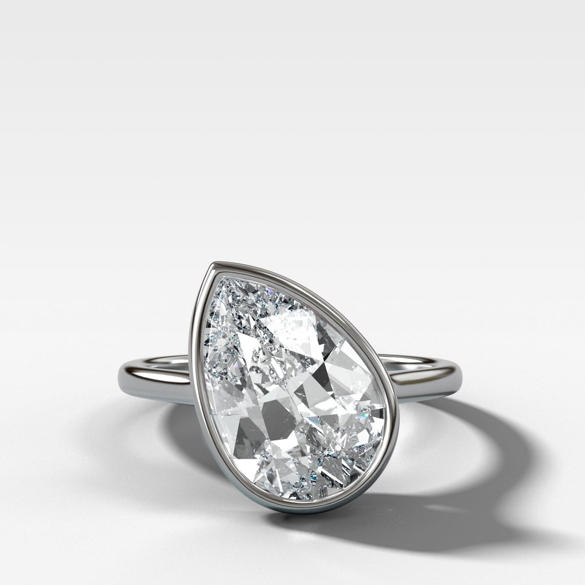 Penumbra Bezel Set Engagement Ring With Tilted Pear Cut - GOODSTONE