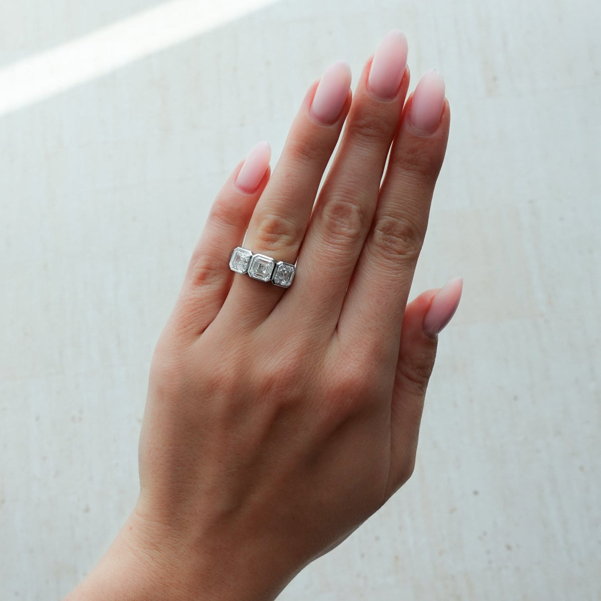 Penumbra Bezel Triad Engagement Ring With Asscher Cut Diamonds - GOODSTONE