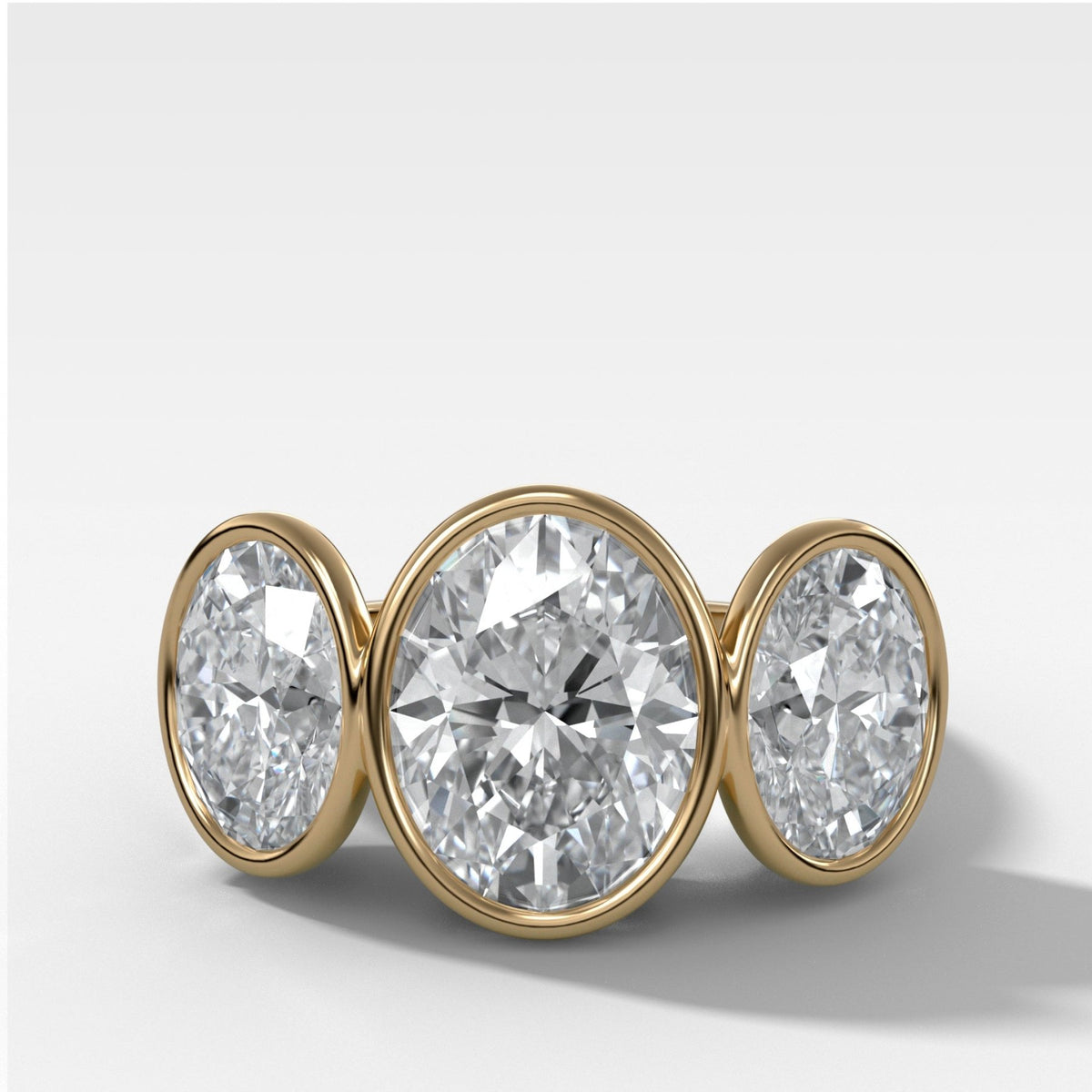 Penumbra Bezel Triad Engagement Ring With Oval Cut Diamonds - GOODSTONE