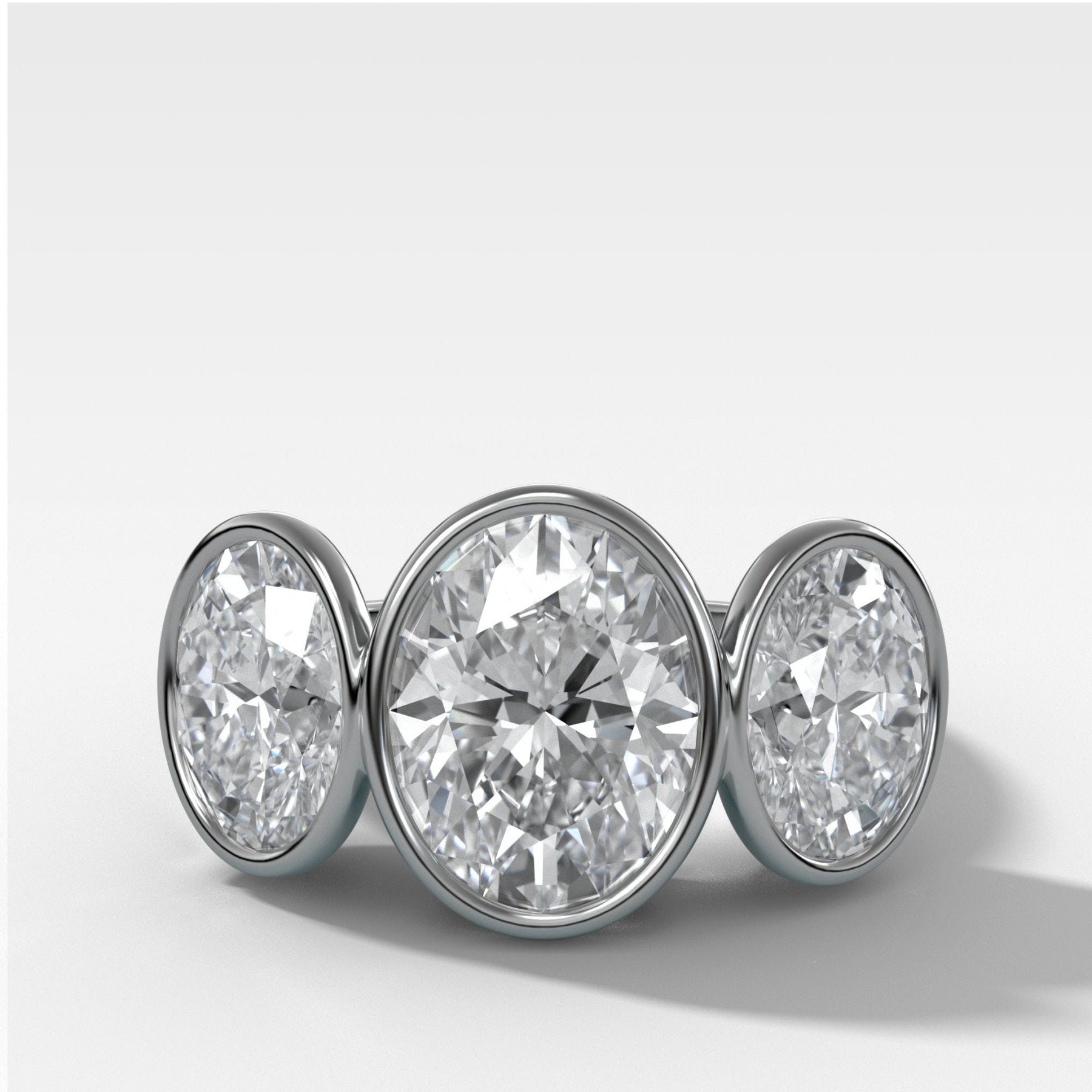 Penumbra Bezel Triad Engagement Ring With Oval Cut Diamonds - GOODSTONE