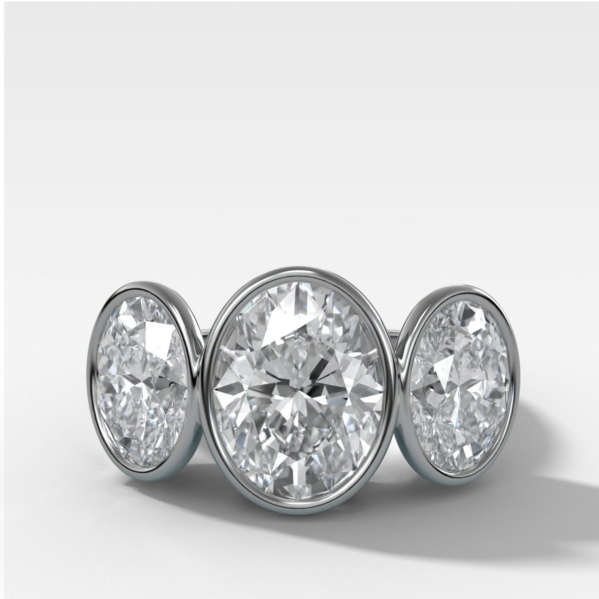 Penumbra Bezel Triad Engagement Ring With Oval Cut Diamonds - GOODSTONE