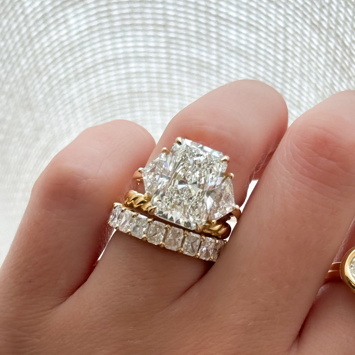 Three Stone Engagement Ring with Shield Side Stones and an Elongated Radiant cut Diamond