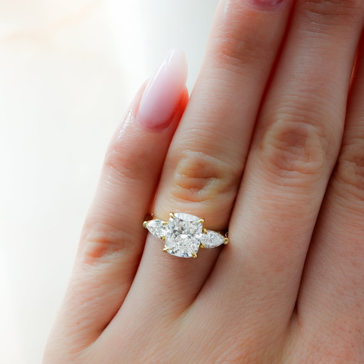 Three Stone Engagement Ring With Pear Side Stones and Elongated Cushion Cut Diamond - GOODSTONE