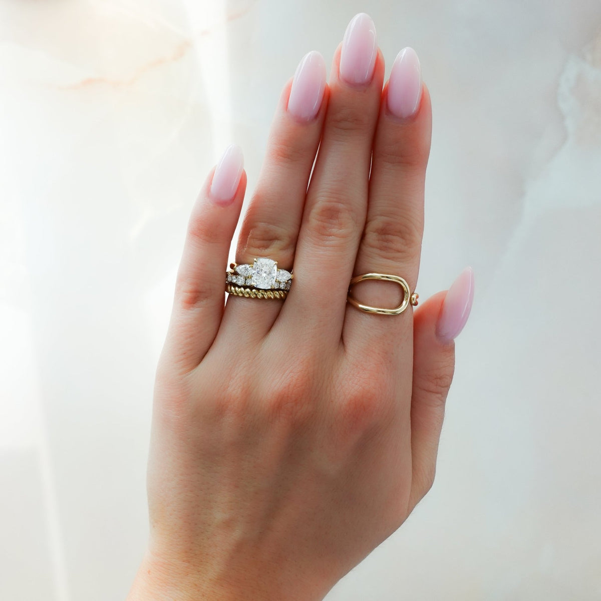 Three Stone Engagement Ring With Pear Side Stones and Elongated Cushion Cut Diamond - GOODSTONE