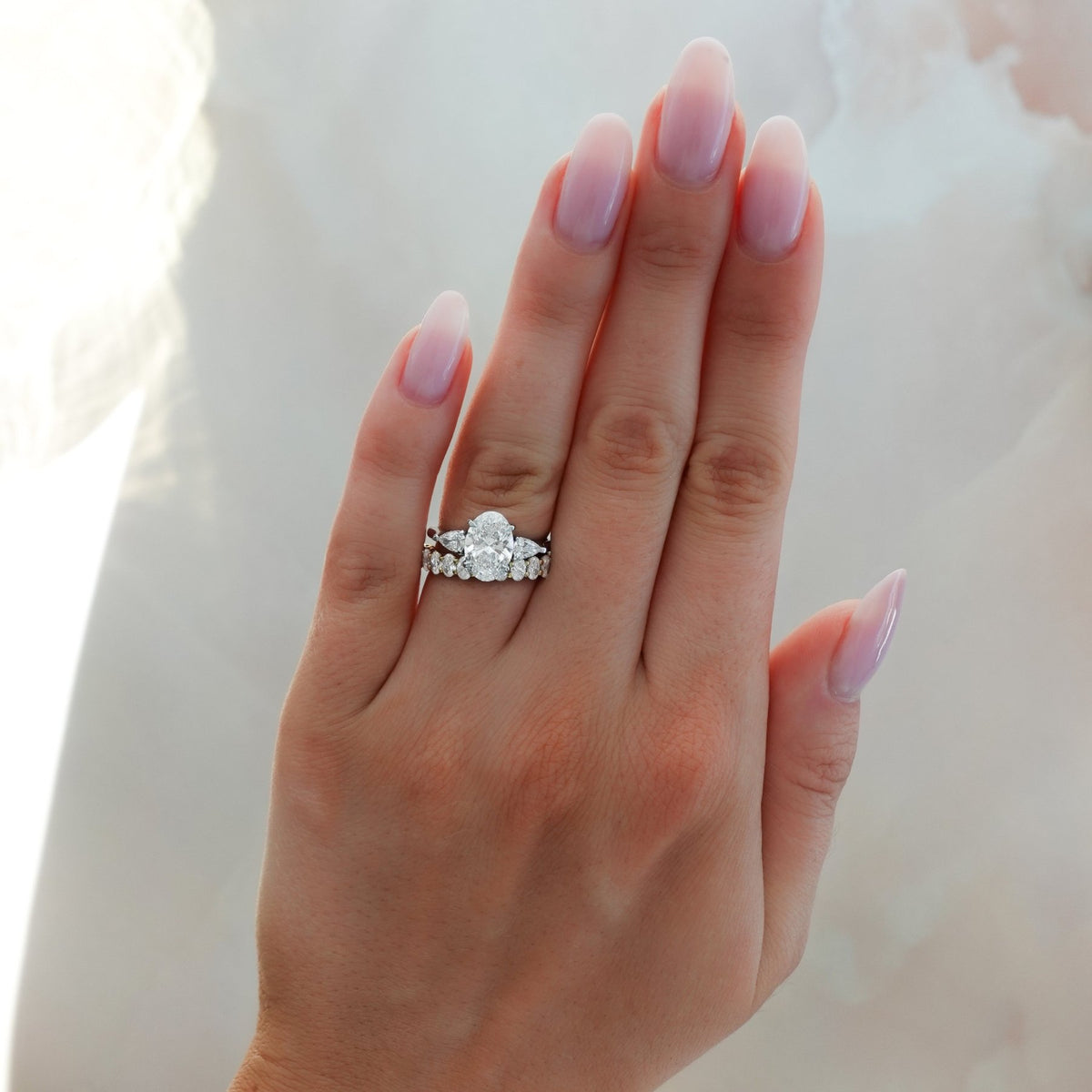Three Stone Engagement Ring With Pear Side Stones and Oval Cut Diamond - GOODSTONE