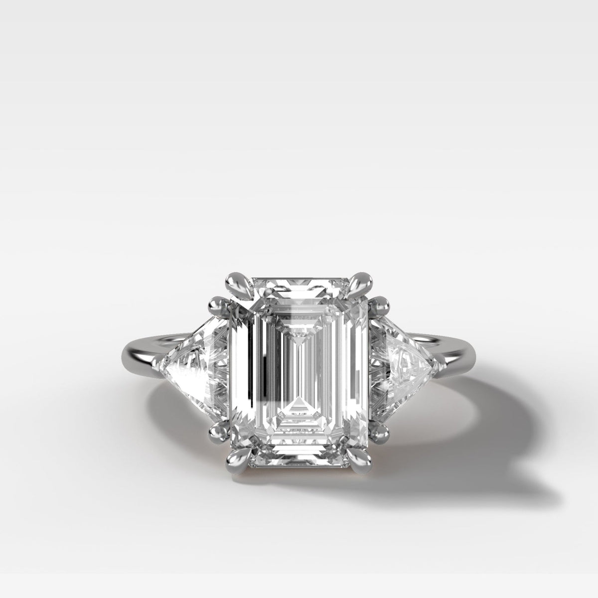 Three Stone Engagement Ring with Shield Side Stones and an Emerald Cut Diamond - GOODSTONE