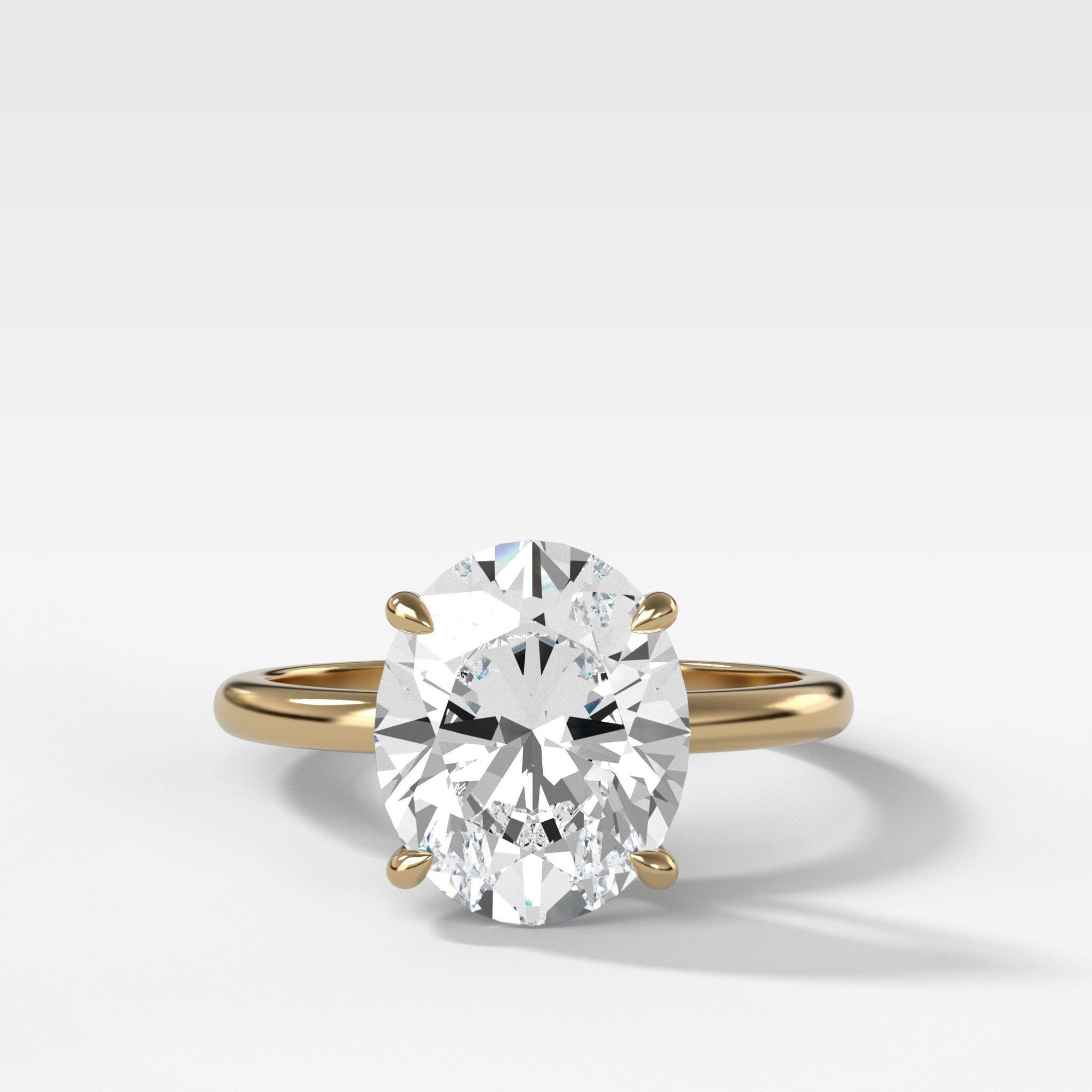Crescent Solitaire With Oval Cut by Good Stone in Yellow Gold