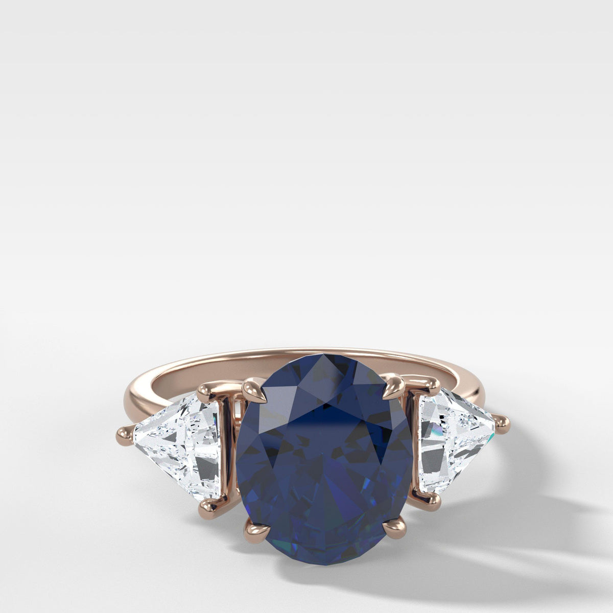 Oval Cut Sapphire Three Stone Engagement Ring With Trilliant Cut Diamond Sides by Good Stone in Rose Gold