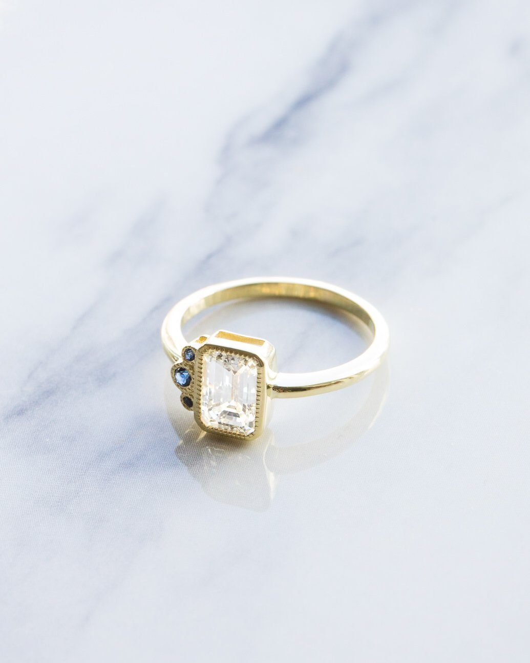 Blue Cluster Engagement Ring With Emerald Cut by Good Stone in Yellow Gold