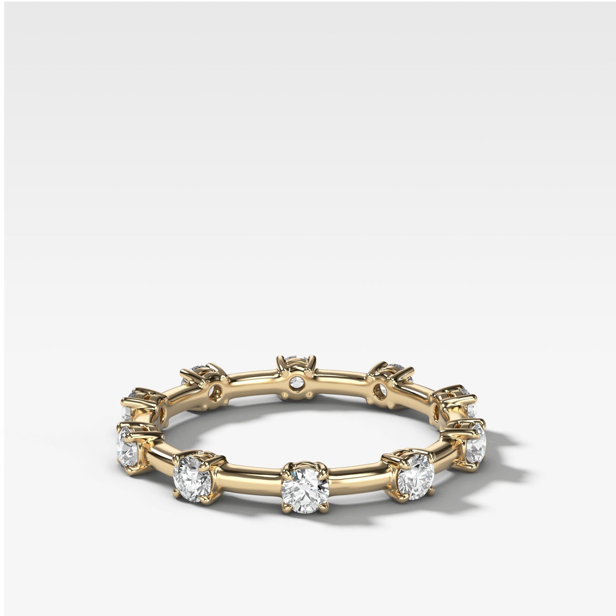 Claw Diamond Band: Spaced Eternity Band by Good Stone in Yellow Gold