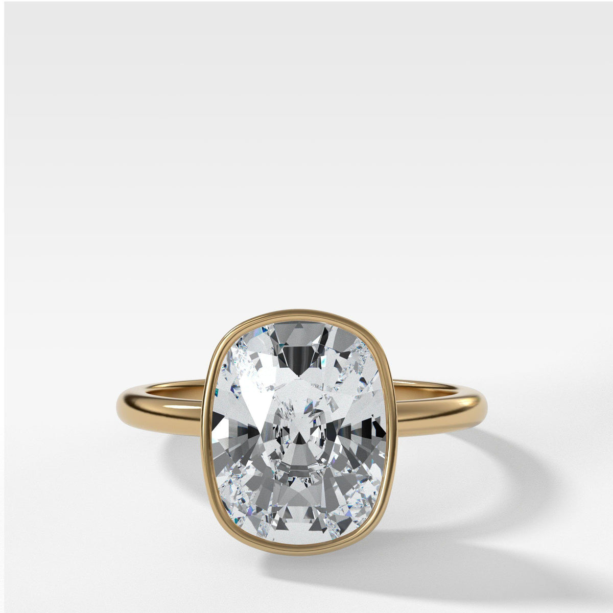 Bezel Penumbra Solitaire With Elongated Cushion Cut by Good Stone in Yellow Gold