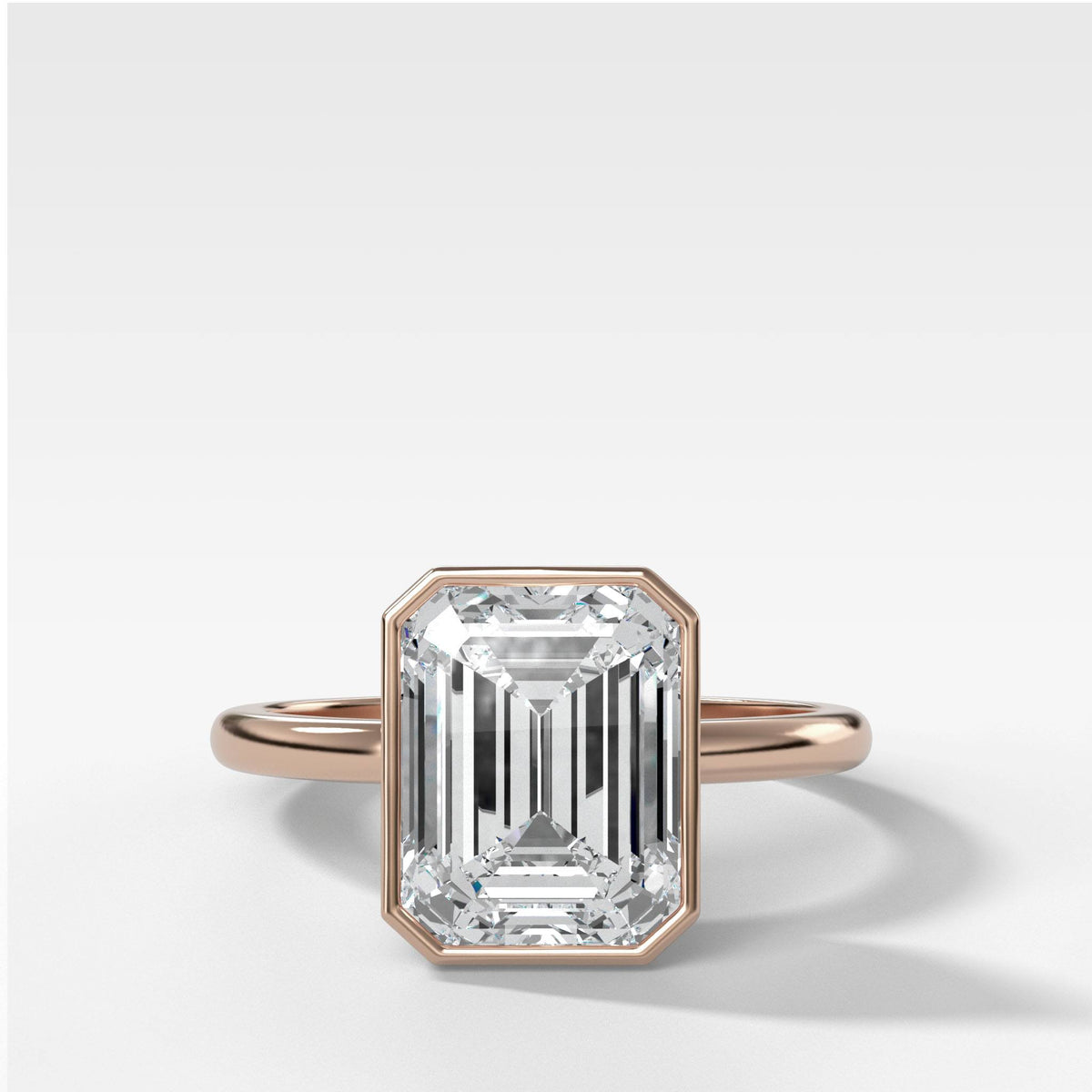 Bezel Penumbra Solitaire With Emerald Cut in Rose Gold by Good Stone