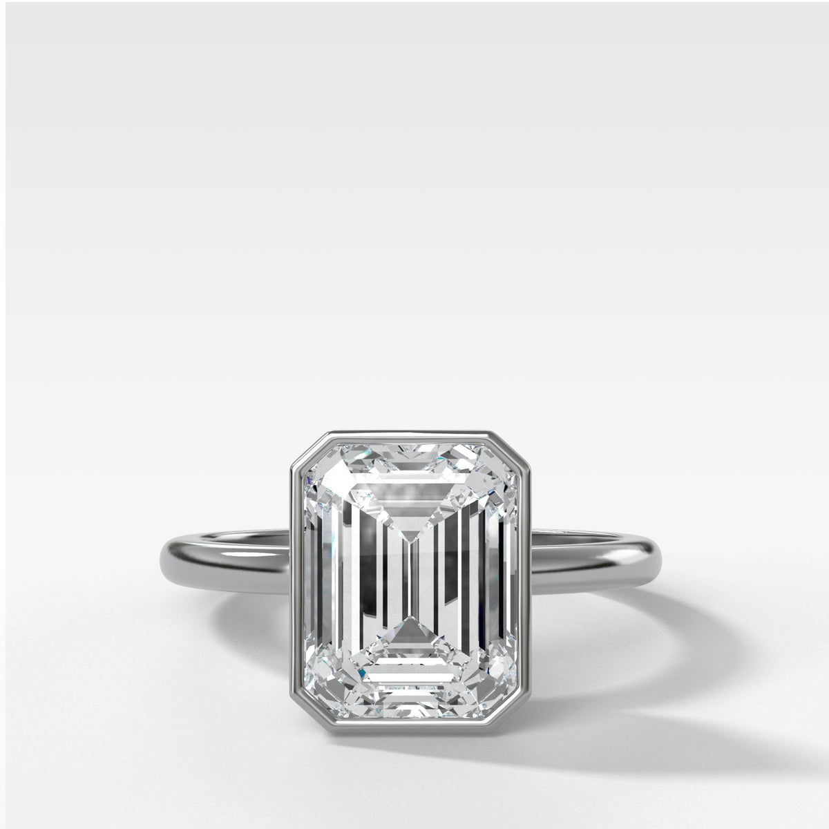 Bezel Penumbra Solitaire With Emerald Cut in White Gold by Good Stone