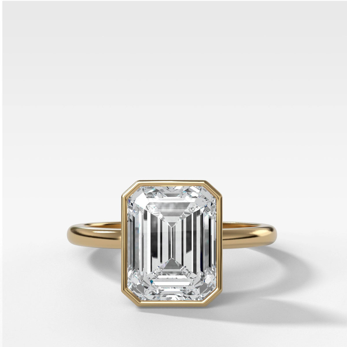 Bezel Penumbra Solitaire With Emerald Cut in Yellow Gold by Good Stone