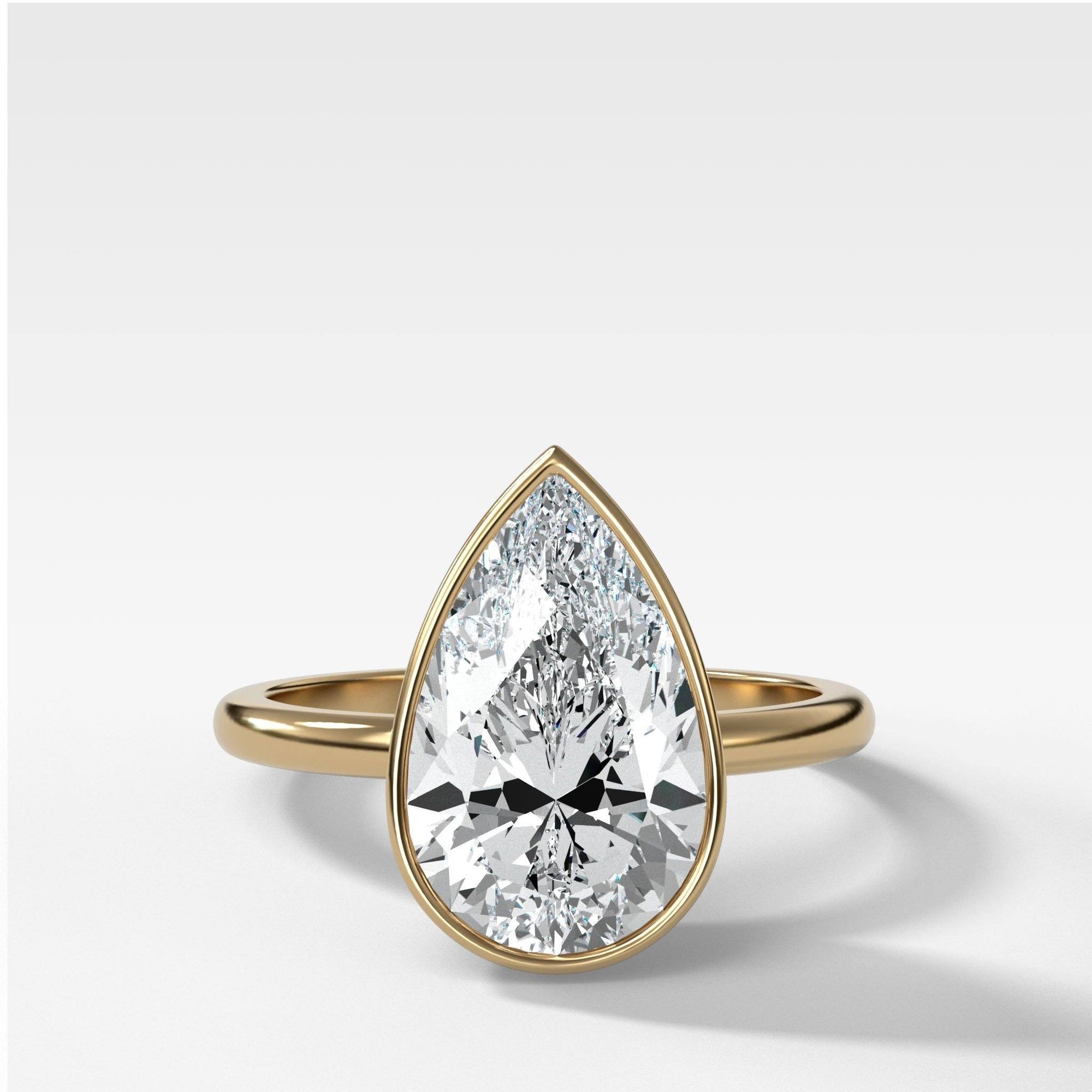 Bezel Penumbra Solitaire With Pear Cut by Good Stone in Yellow Gold