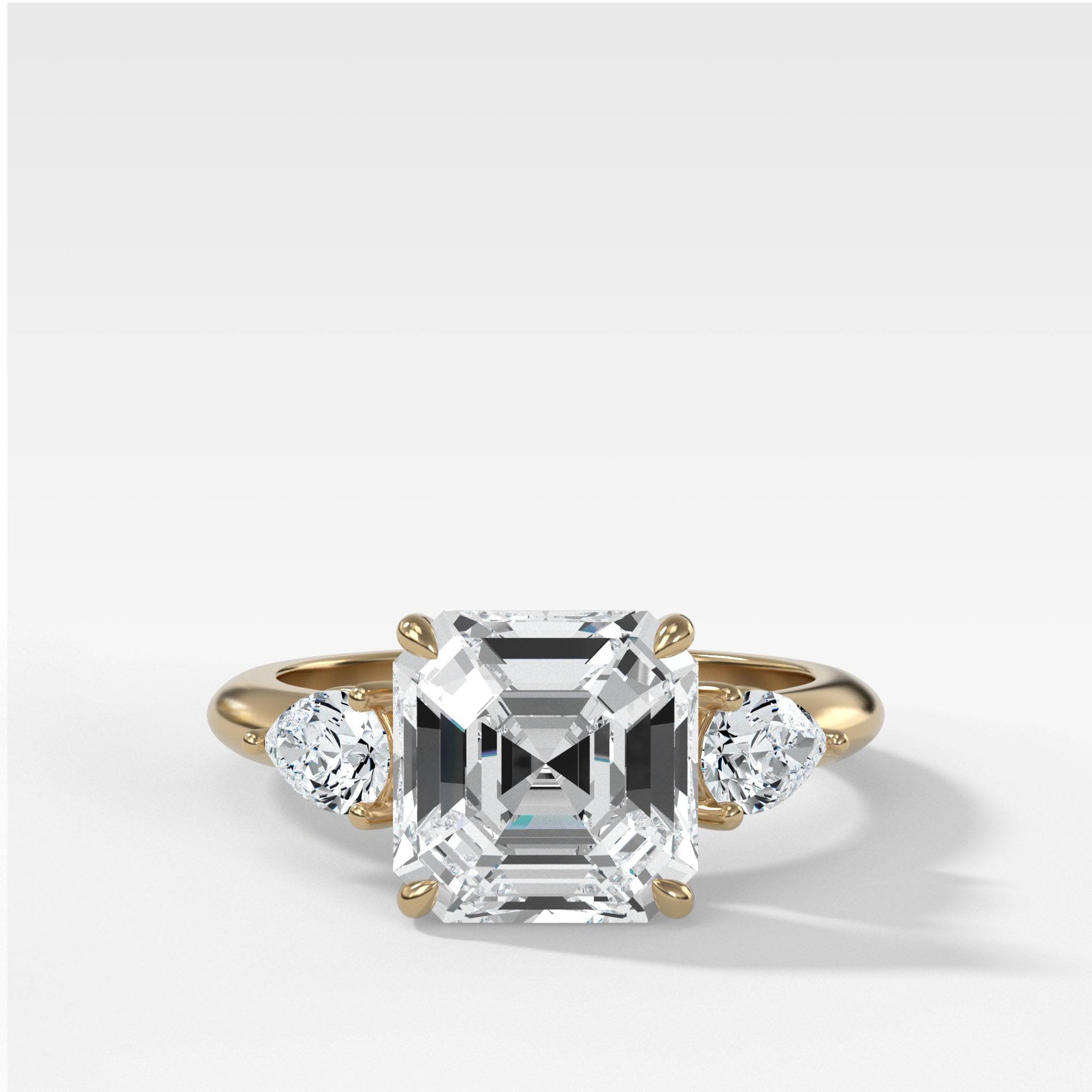 Three Stone Engagement Ring With Pear Side Stones and Asscher Cut by Good Stone in Yellow Gold