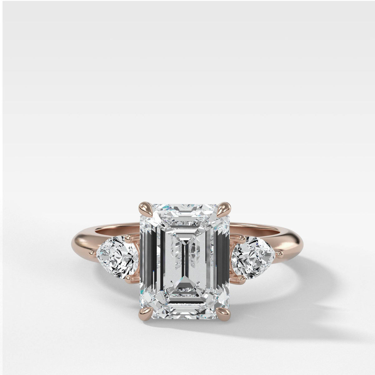 Three Stone Engagement Ring With Pear Side Stones and Emerald Cut by Good Stone in Rose Gold
