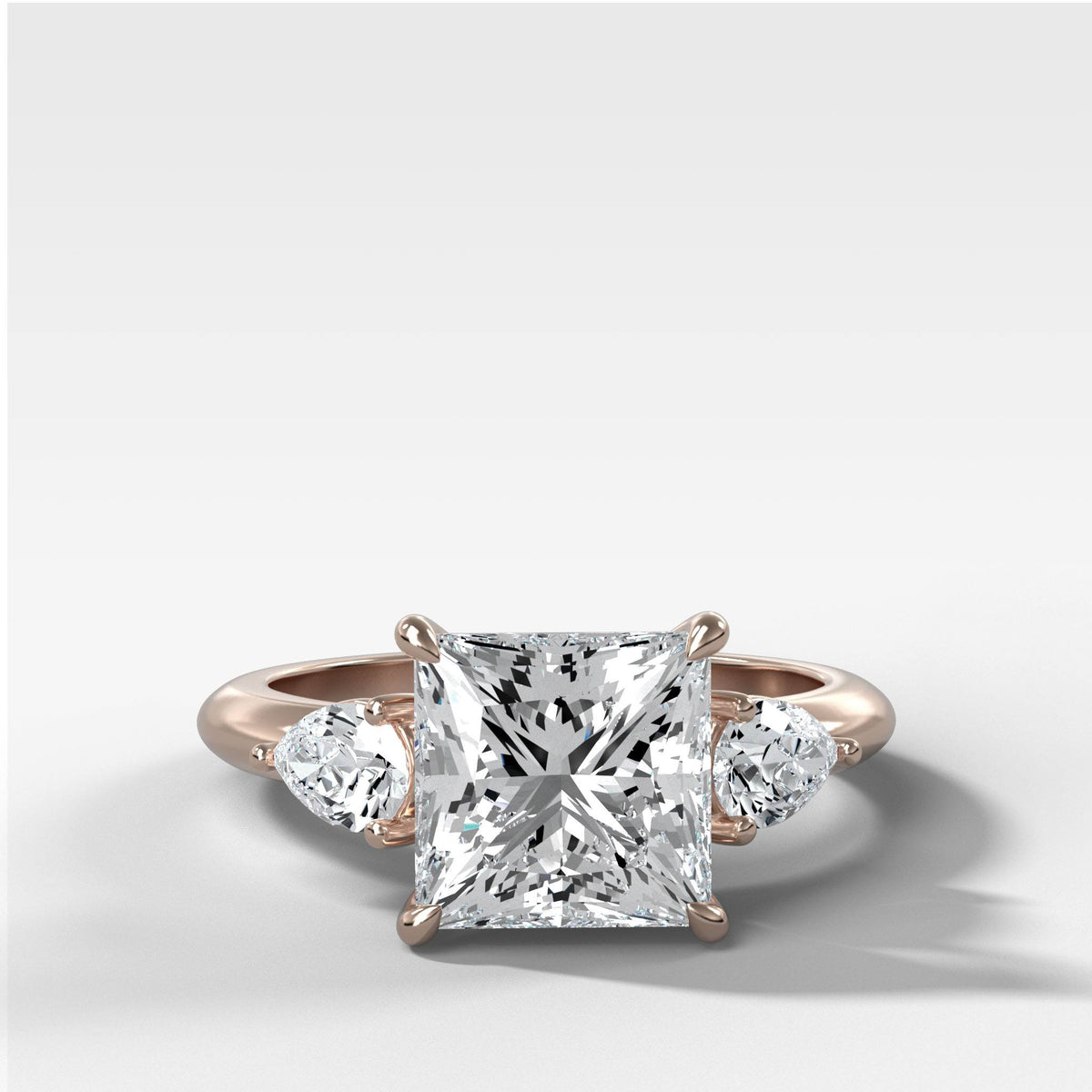 Three Stone Engagement Ring With Pear Side Stones and Princess Cut by Good Stone in Rose Gold