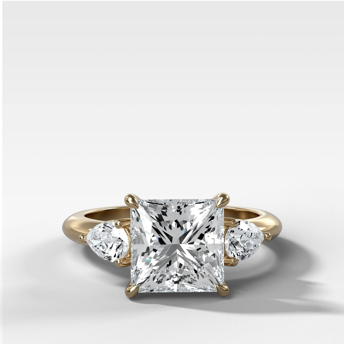 Three Stone Engagement Ring With Pear Side Stones and Princess Cut by Good Stone in Yellow Gold