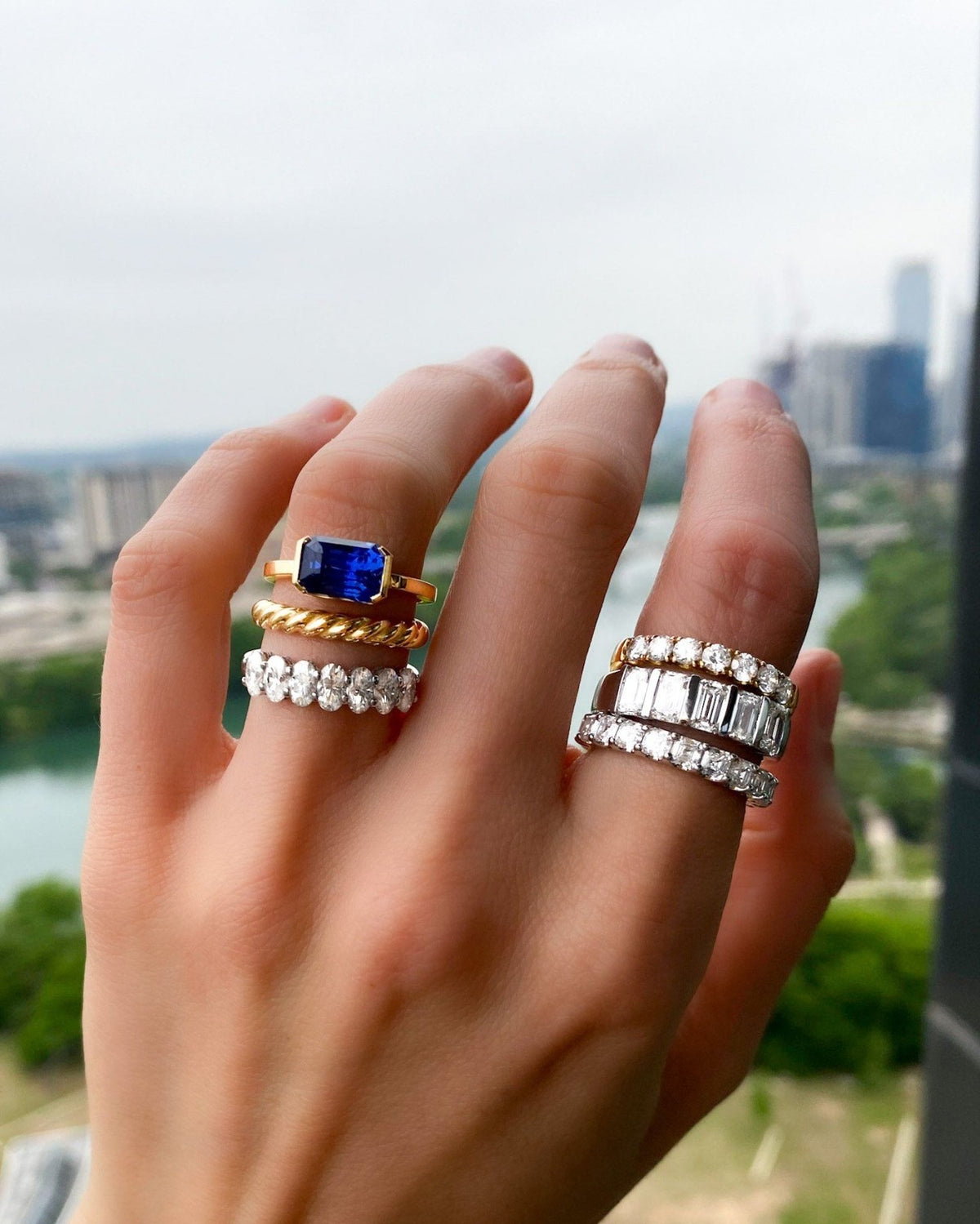 East West Half Bezel Solitaire With Emerald Cut Ceylon Blue Sapphire - GOODSTONE