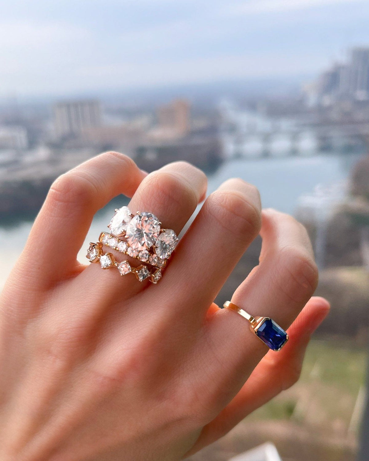 East West Half Bezel Solitaire With Emerald Cut Ceylon Blue Sapphire - GOODSTONE