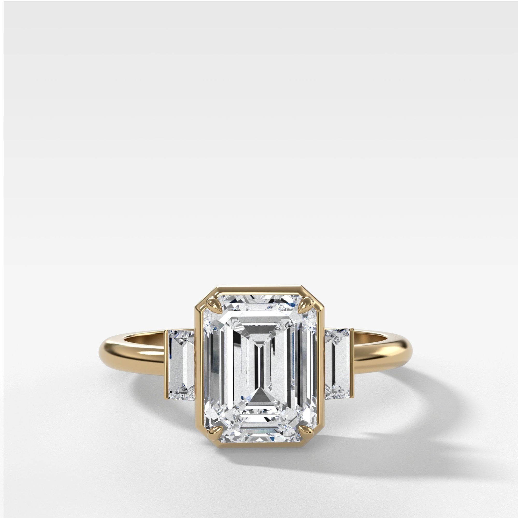 Three Stone Engagement Ring With Straight Baguette Side Stones and Emerald Cut by Good Stone in Yellow Gold