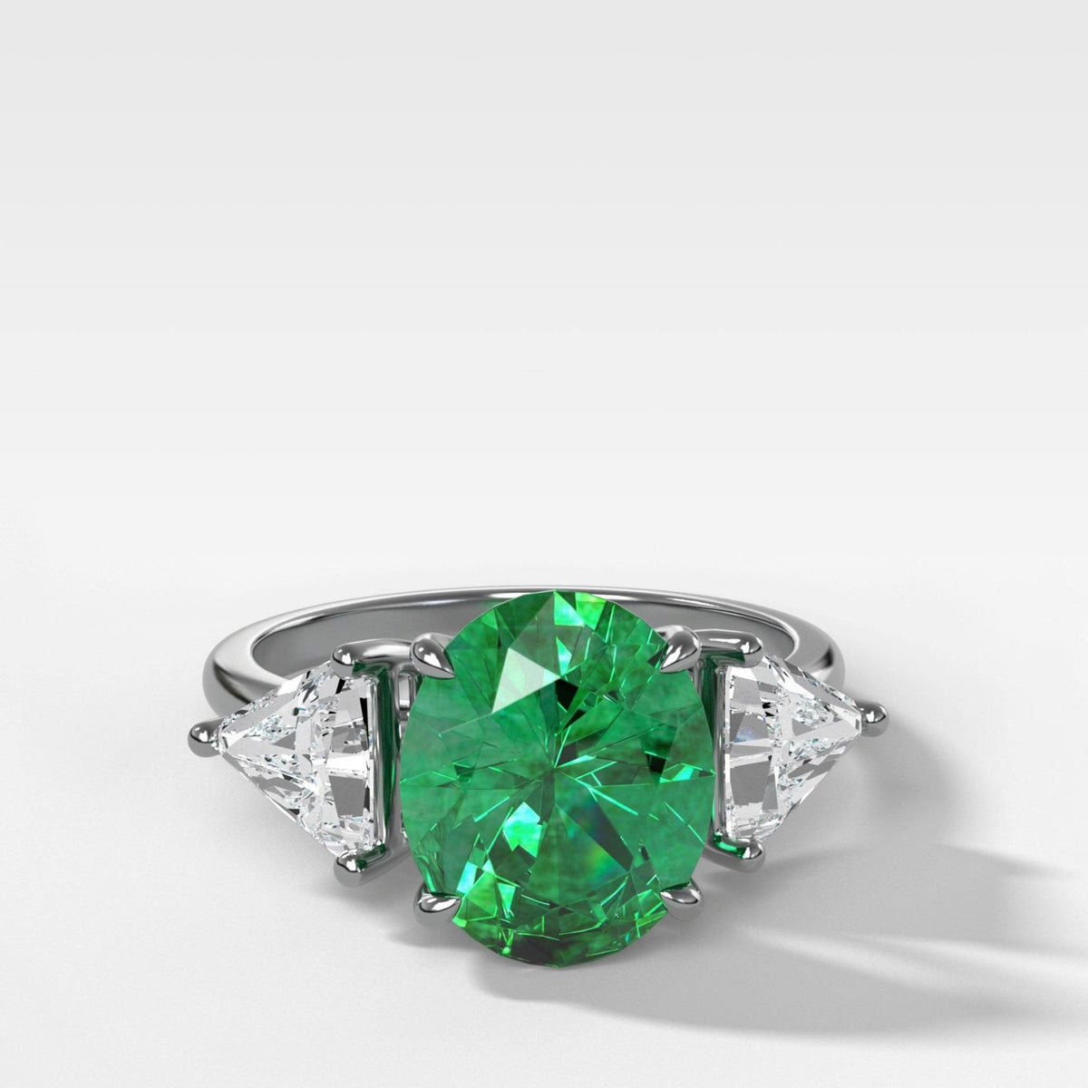 Oval Cut Emerald Three Stone Engagement Ring With Trilliant Cut Diamond Sides - GOODSTONE