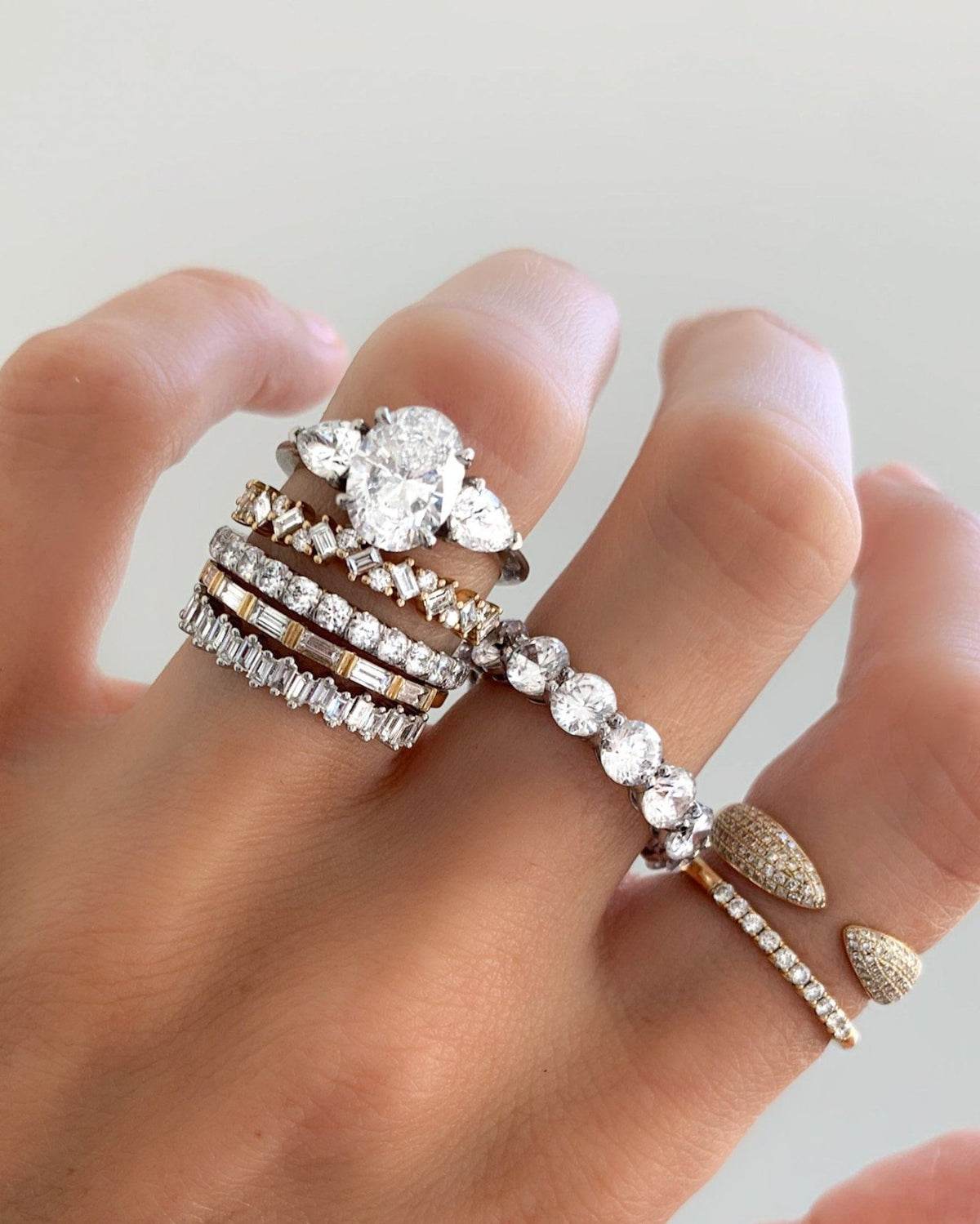 Three Stone Engagement Ring With Pear Side Stones and Oval Cut Diamond - GOODSTONE